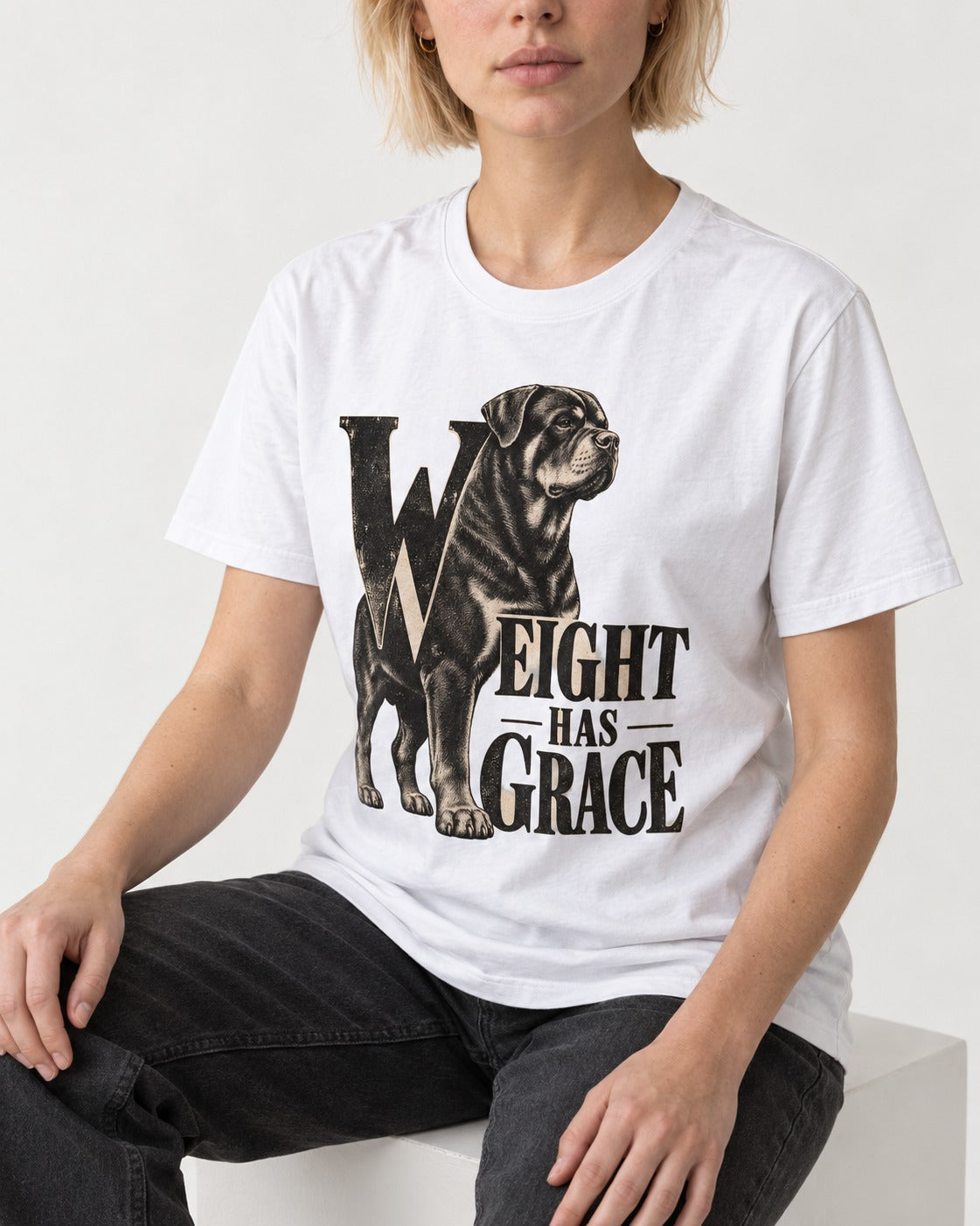 Rottweiler Weight Has Grace T-Shirt in White, worn by a seated model