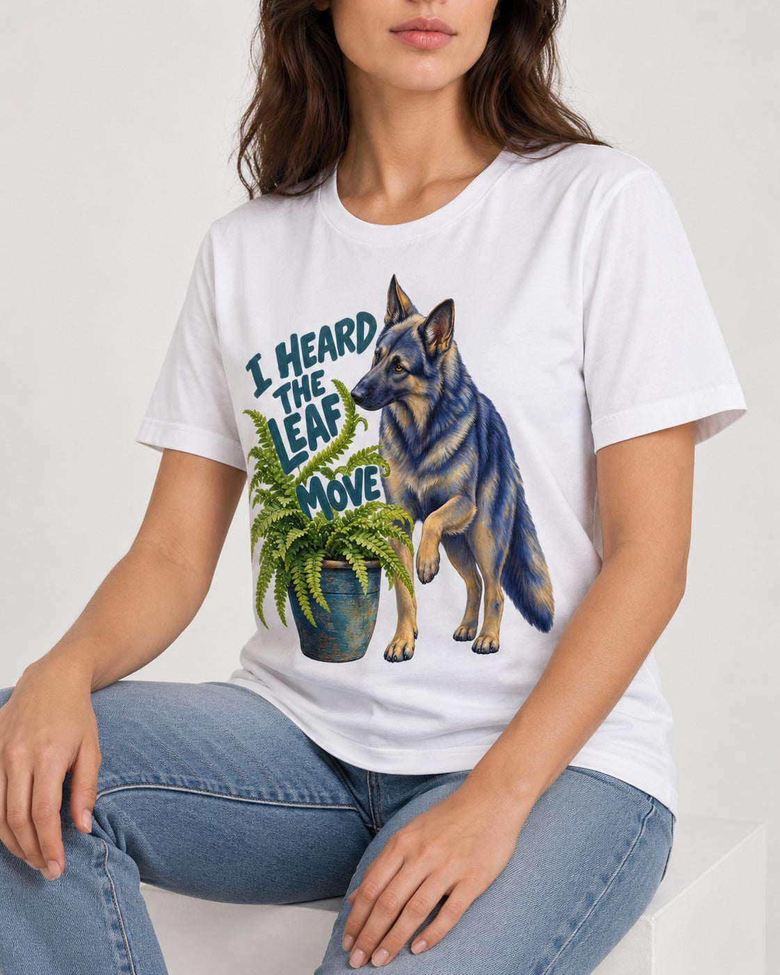 German Shepherd Dog Heard the Leaf Move T-Shirt in White, worn by a seated model