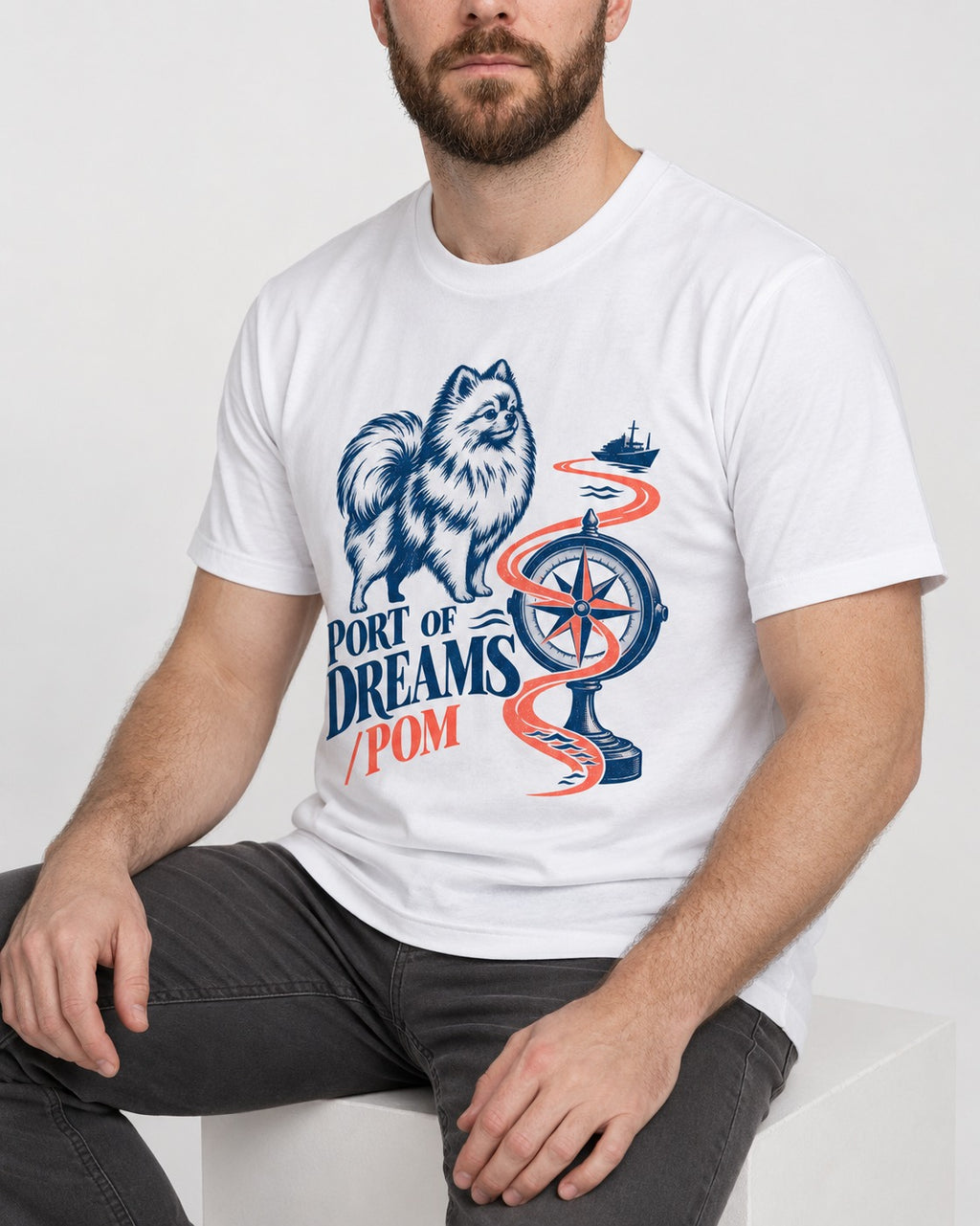 Pomeranian Port of Dreams T-Shirt in White, worn by a seated model