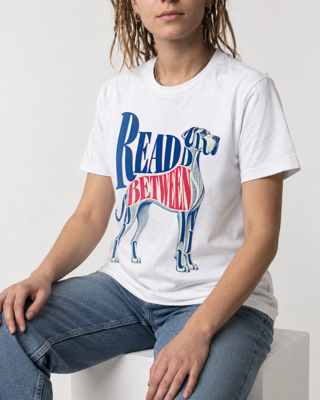 Read Between the Lines Great Dane T-Shirt in White, worn by a seated model