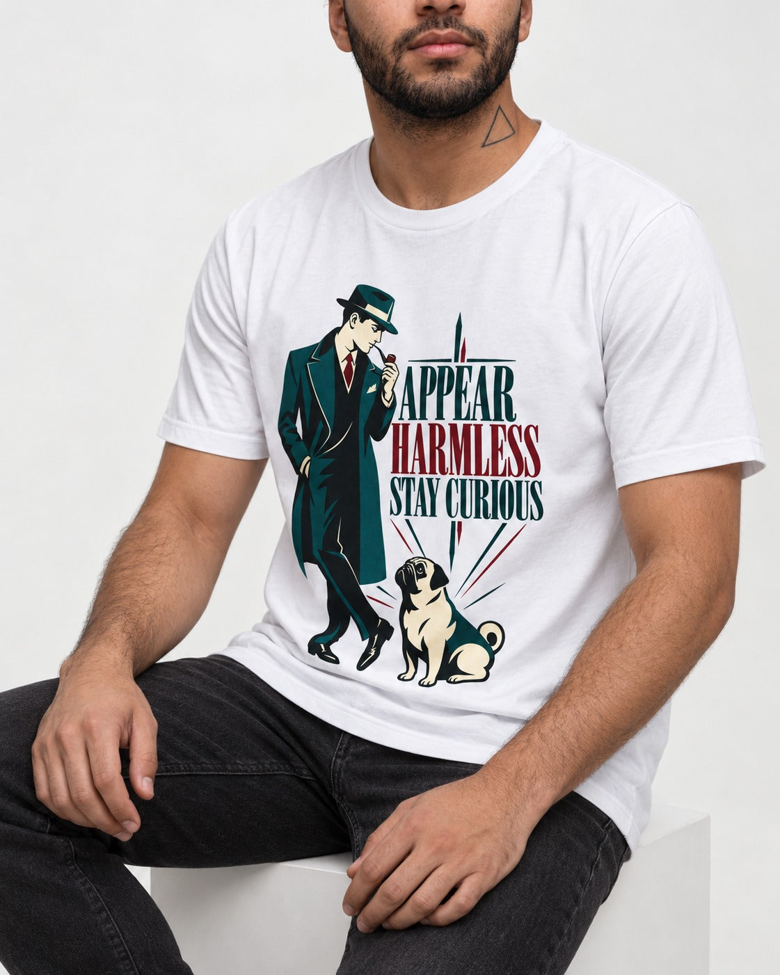 Pug Appear Harmless Stay Curious T-Shirt in White, worn by a seated model