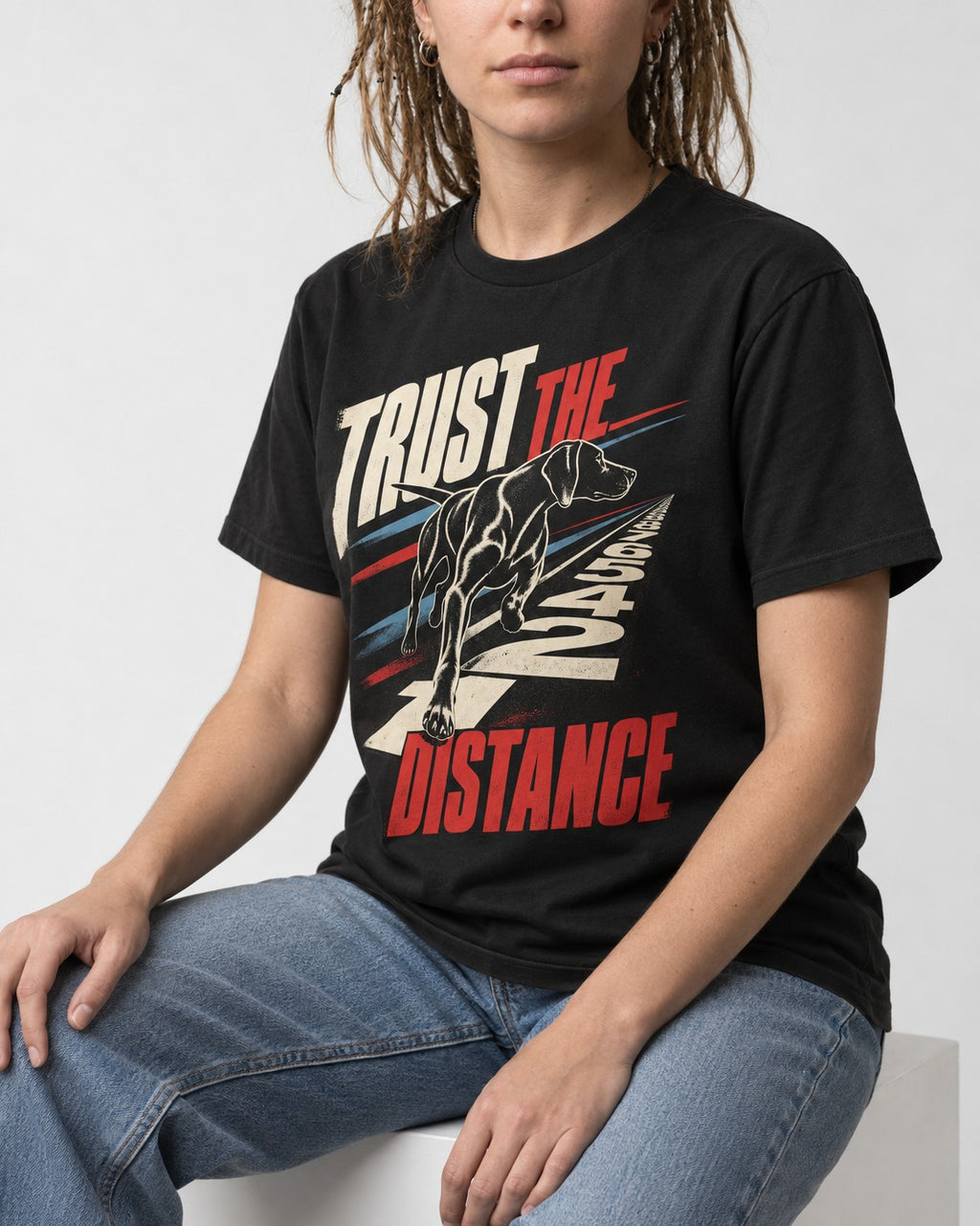 Trust the Distance German Shorthaired Pointer Graphic T-Shirt in Black, worn by a seated model
