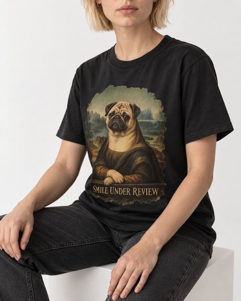 Pug Smile Under Review Mona Lisa Graphic T-Shirt in Black, worn by a seated model