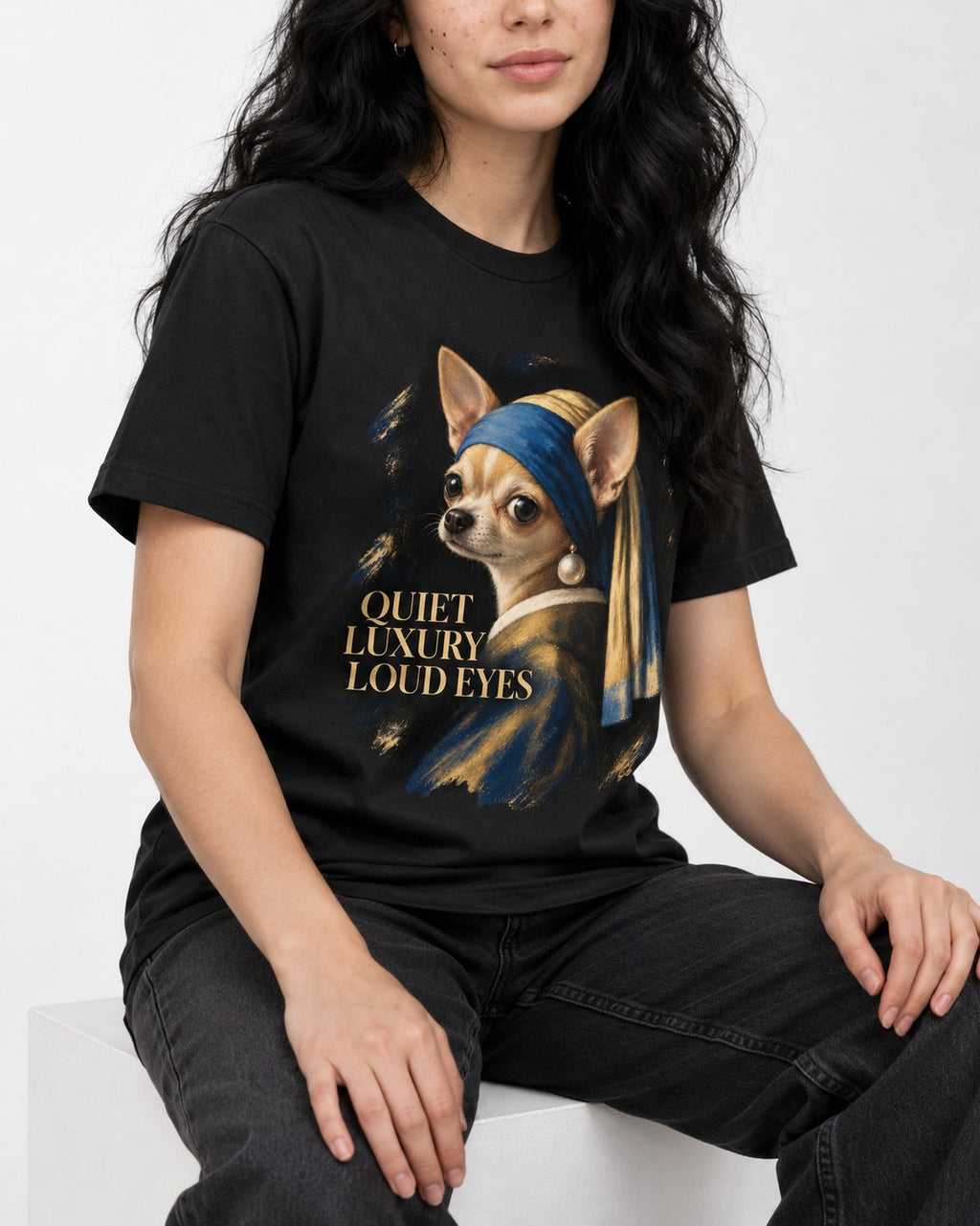 Chihuahua Quiet Luxury Loud Eyes Pearl Earring Portrait T-Shirt in Black, worn by a seated model