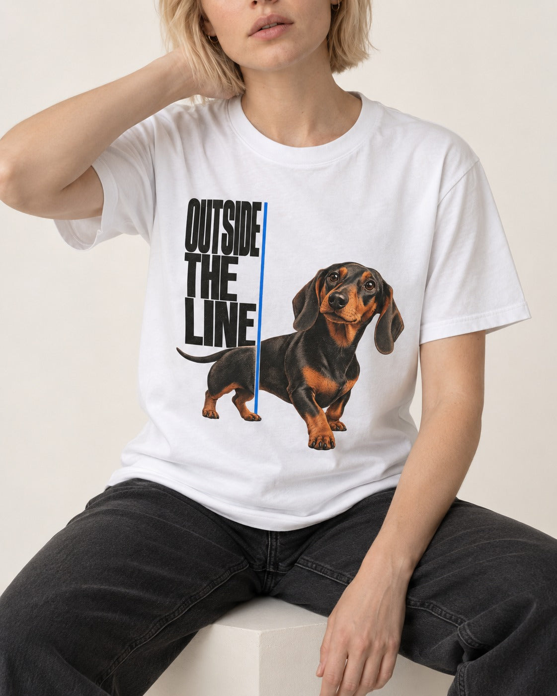 Dachshund Outside the Line T-Shirt in White, worn by a seated model