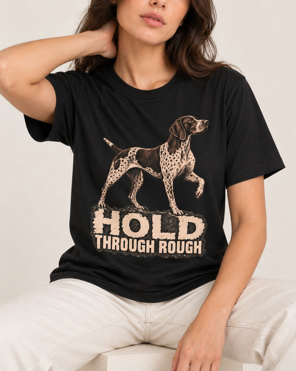 German Shorthaired Pointer Hold Through Rough Vintage Graphic T-Shirt in Black, worn by a seated model