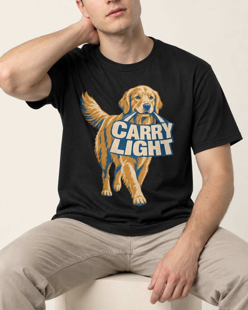 Golden Retriever Carry Light Sign Graphic T-Shirt in Black, worn by a seated model