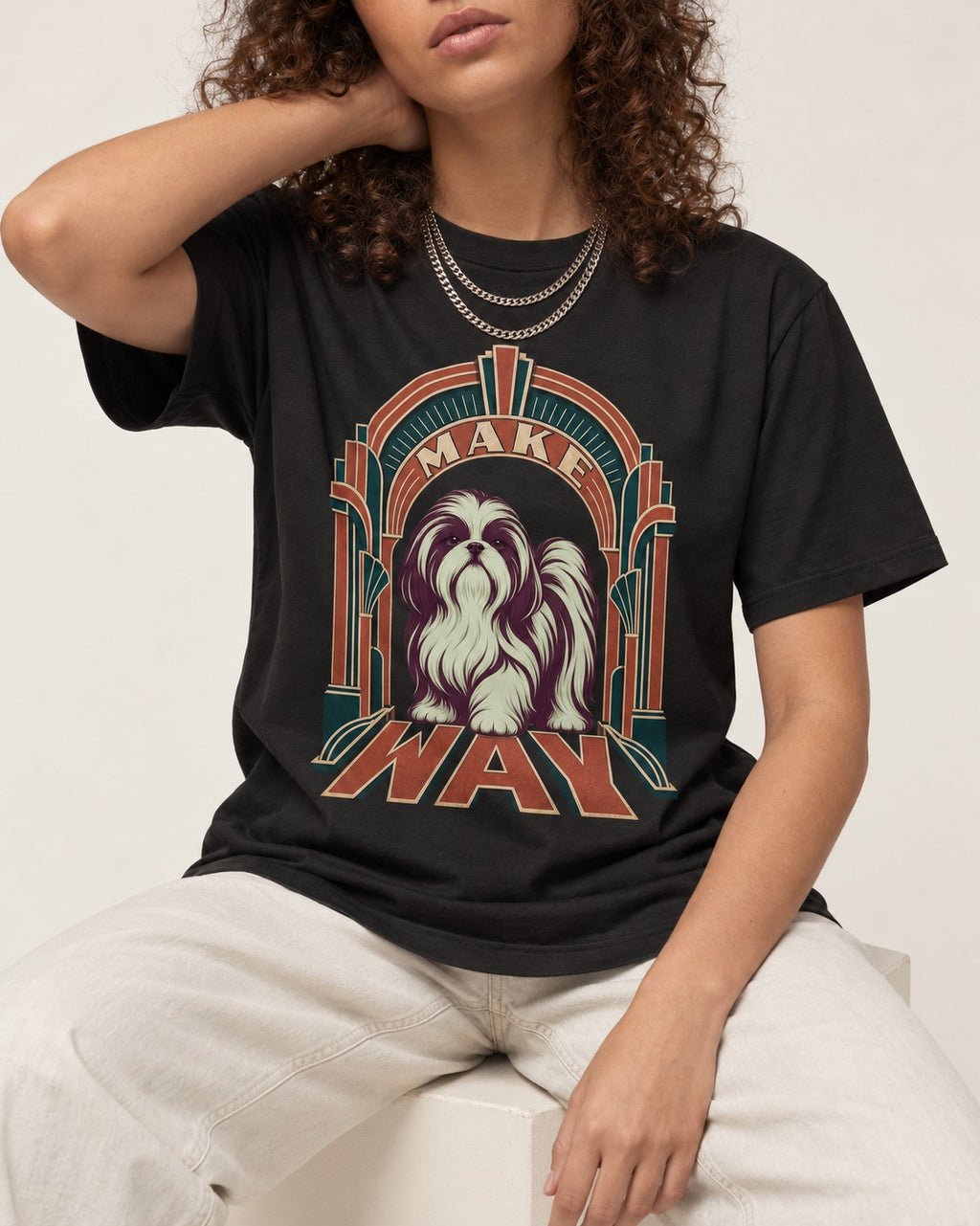 Shih Tzu Make Way Art Deco Arch Portrait T-Shirt in Black, worn by a seated model