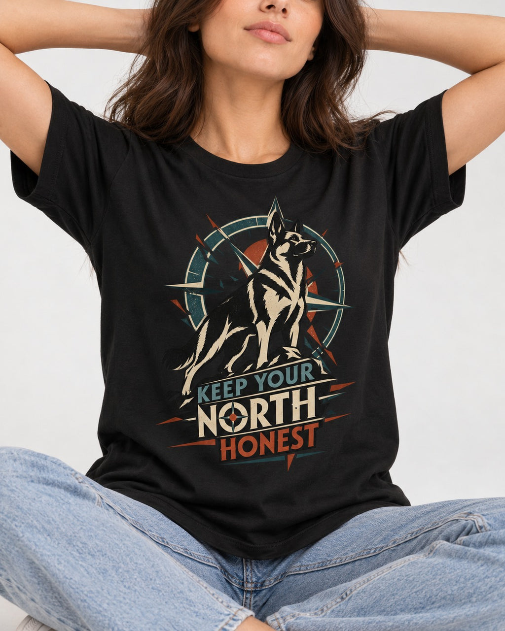 Keep Your North Honest Compass German Shepherd Dog Graphic T-Shirt in Black, worn by a seated model