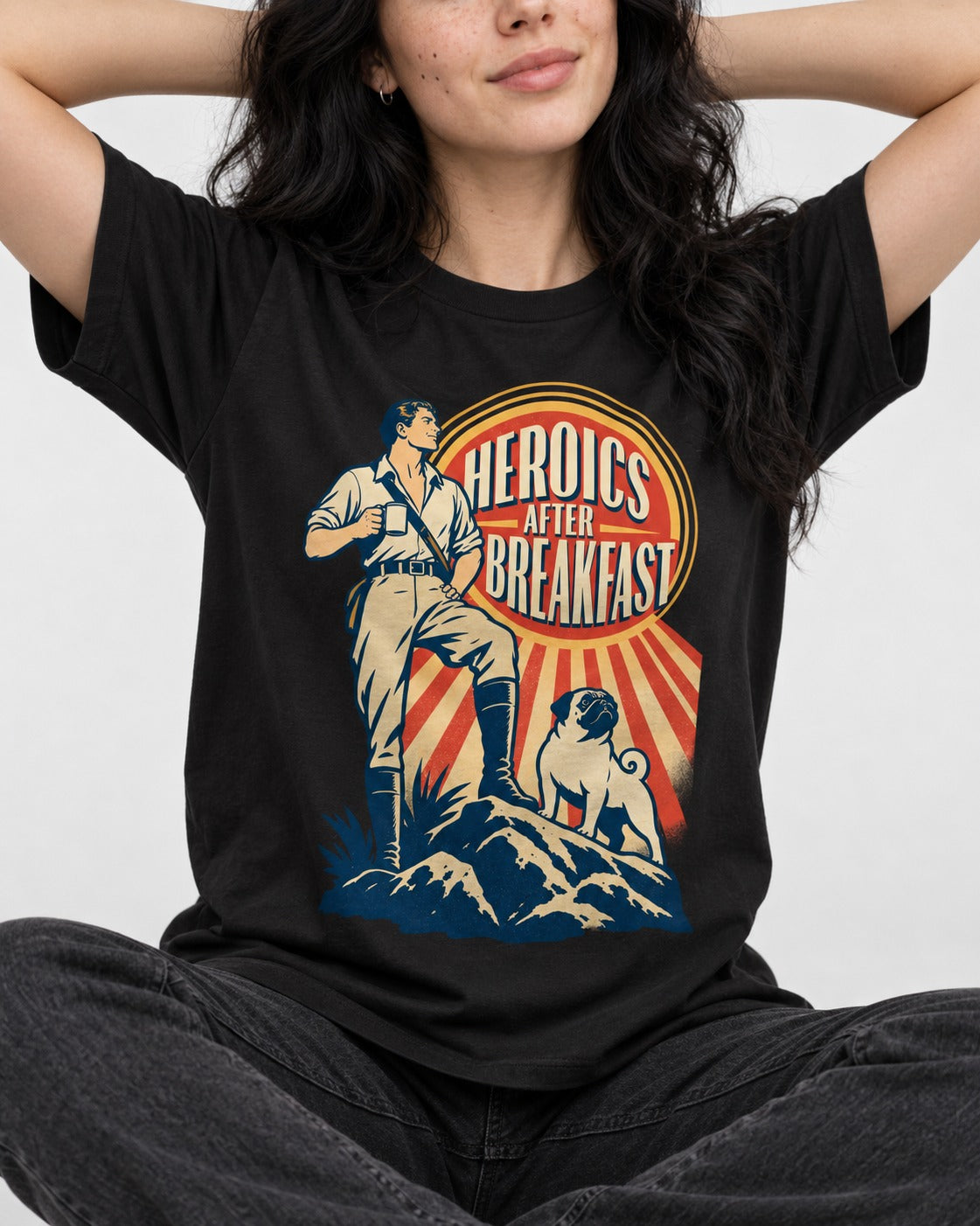 Pug Heroics After Breakfast Adventure Graphic T-Shirt in Black, worn by a seated model