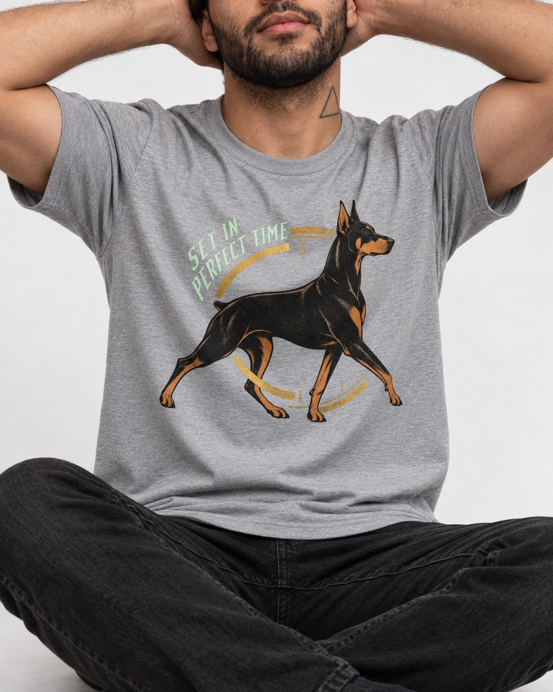 Doberman Set in Perfect Time Clock Stride Graphic T-Shirt in Sport Grey, worn by a seated model