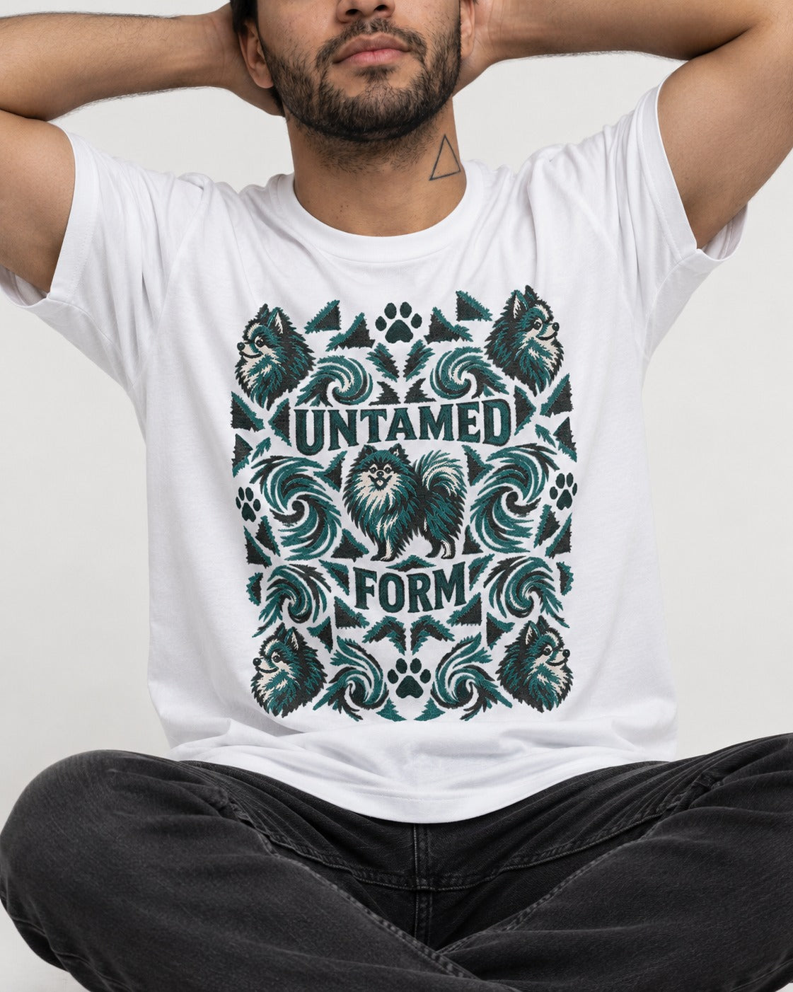 Pomeranian Untamed Form T-Shirt in White, worn by a seated model