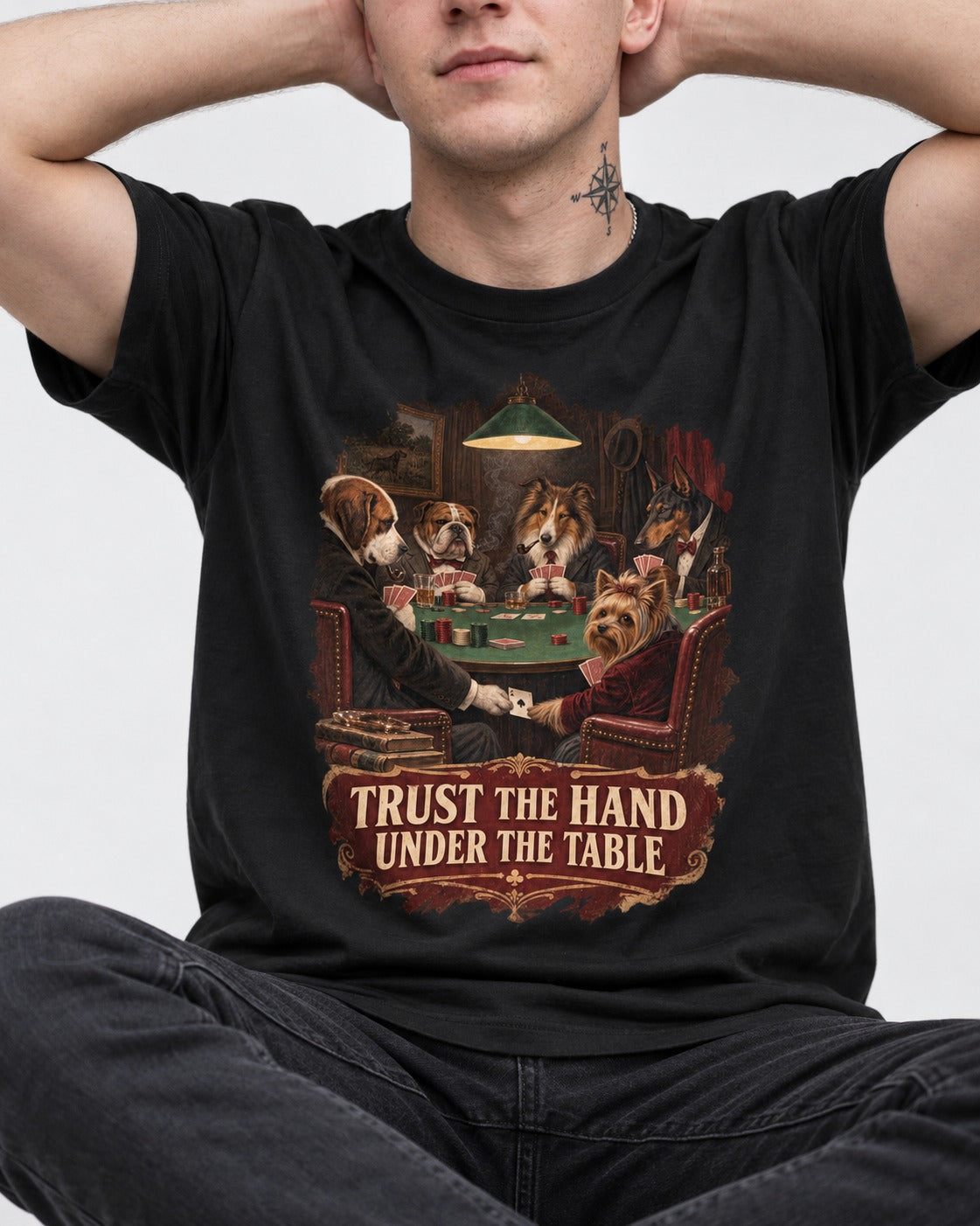 Yorkshire Terrier Trust the Hand Under the Table Poker Dogs Graphic T-Shirt in Black, worn by a seated model