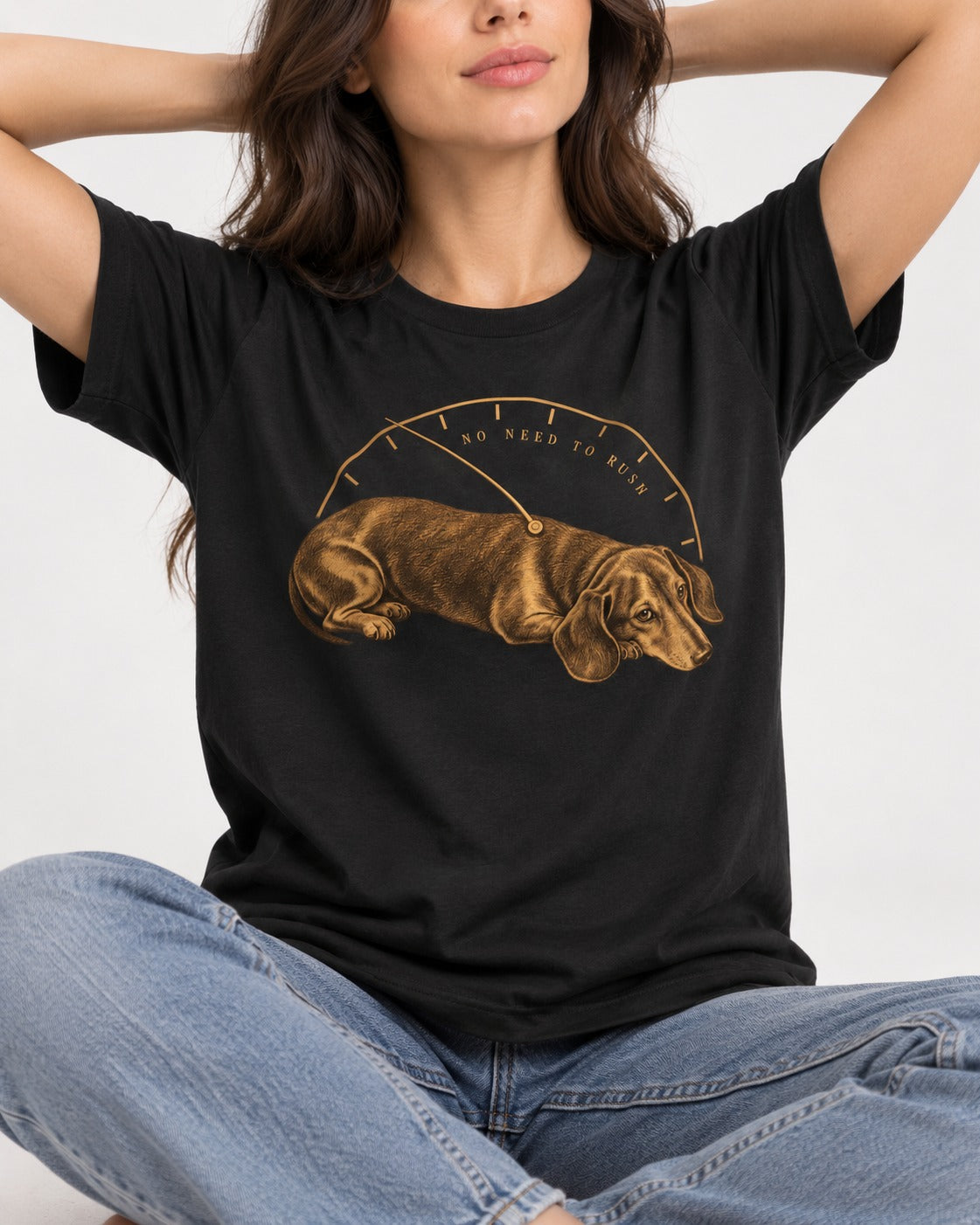 Dachshund No Need To Rush Gauge Graphic T-Shirt in Black, worn by a seated model