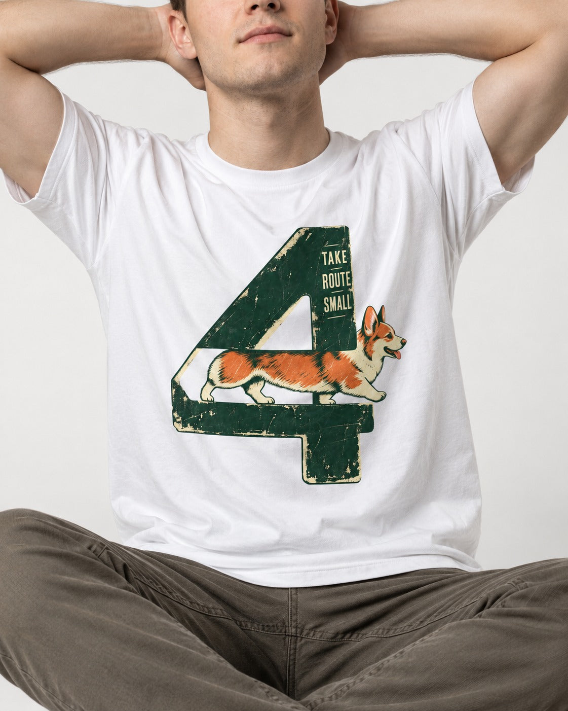 Take Route Small Corgi T-Shirt in White, worn by a seated model