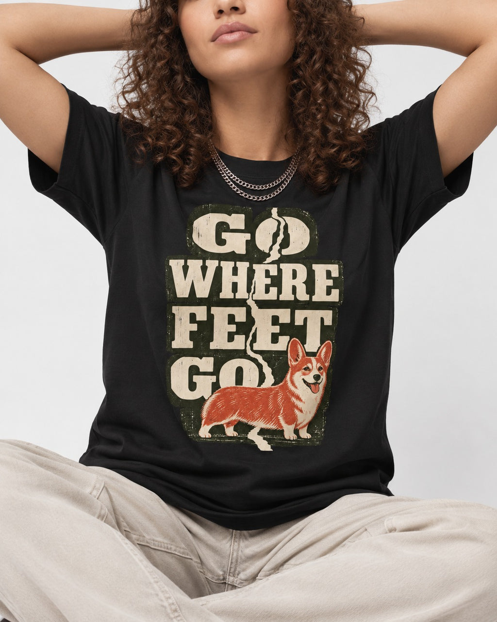 Corgi Go Where Feet Go Path T-Shirt in Black, worn by a seated model