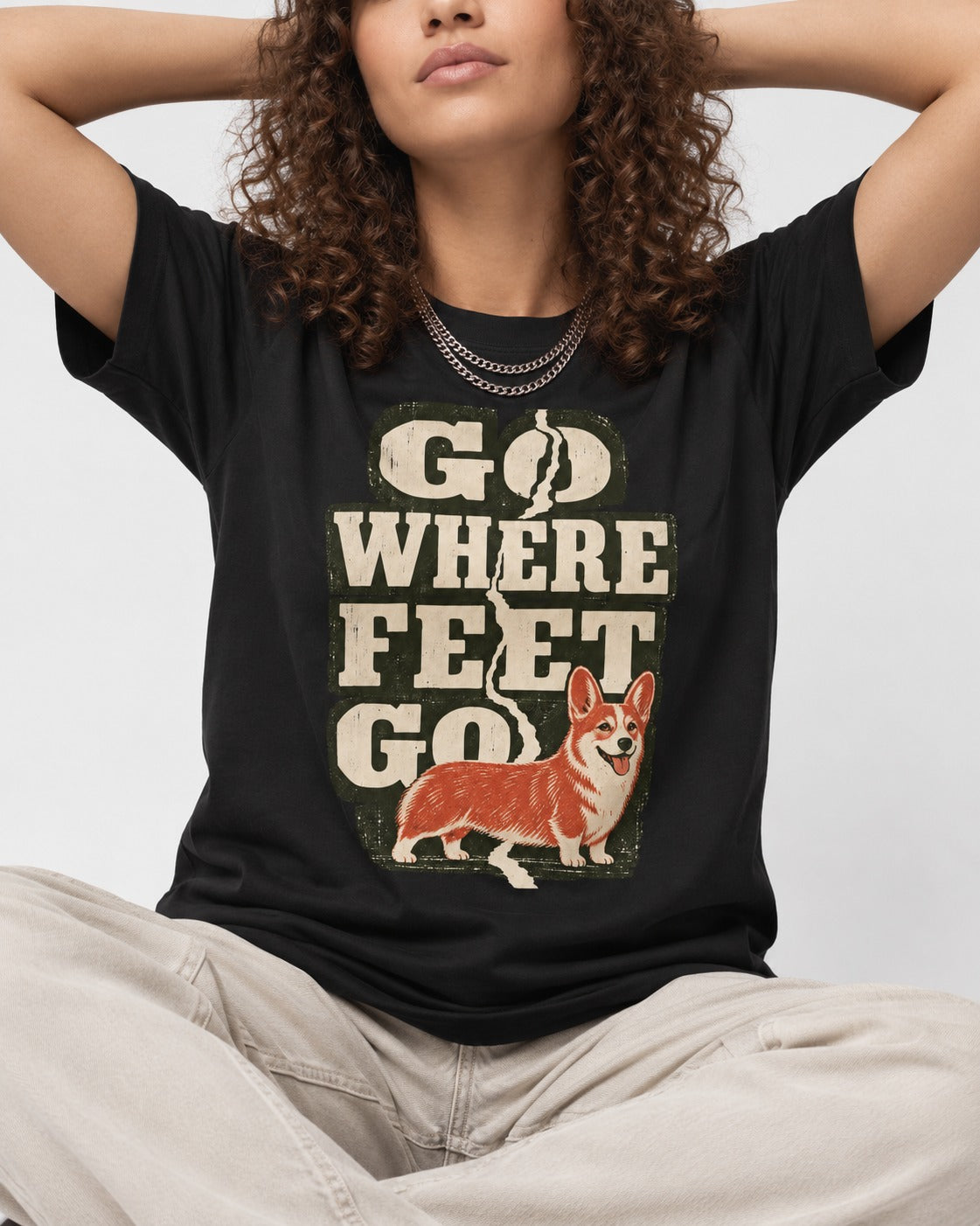 Corgi Go Where Feet Go Path T-Shirt in Black, worn by a seated model