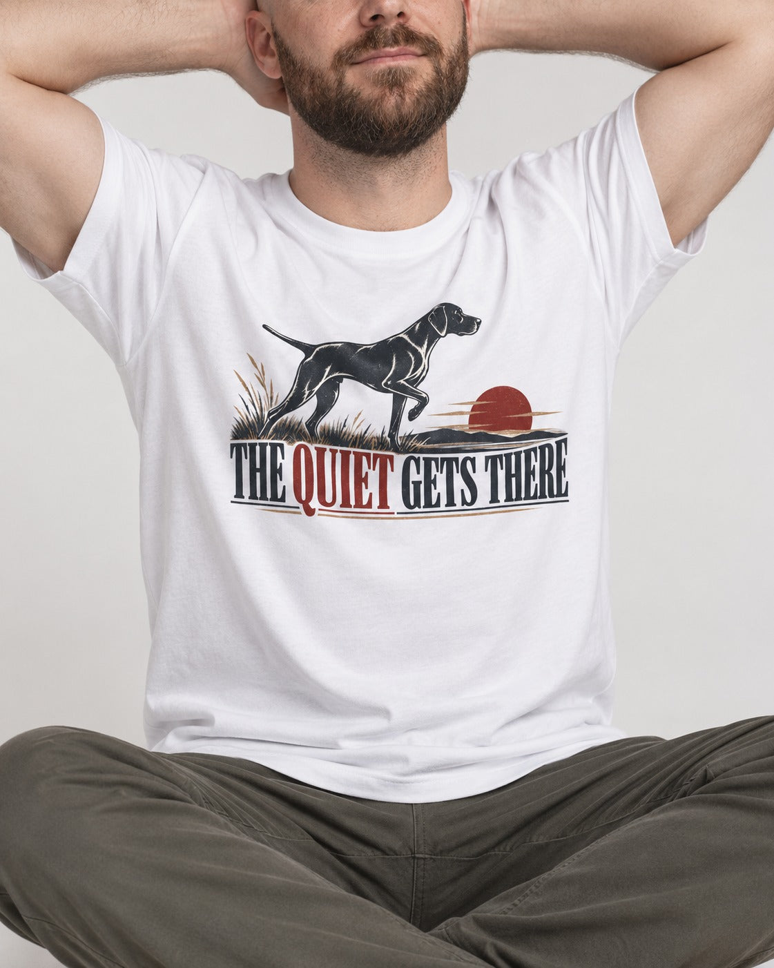 The Quiet Gets There German Shorthaired Pointer T-Shirt in White, worn by a seated model