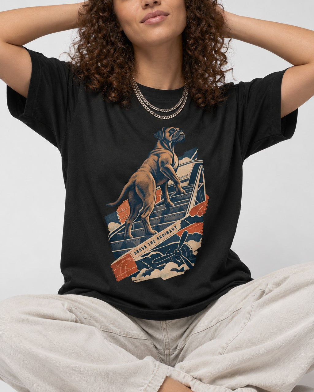 Above the Ordinary Boxer Aviation Graphic T-Shirt in Black, worn by a seated model