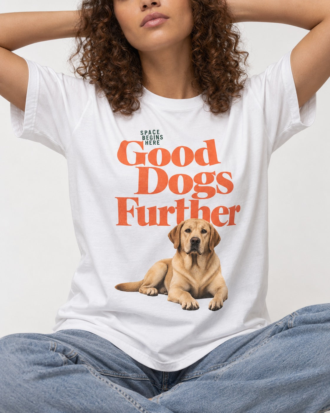 Good Labrador Retriever Goes Further T-Shirt in White, worn by a seated model