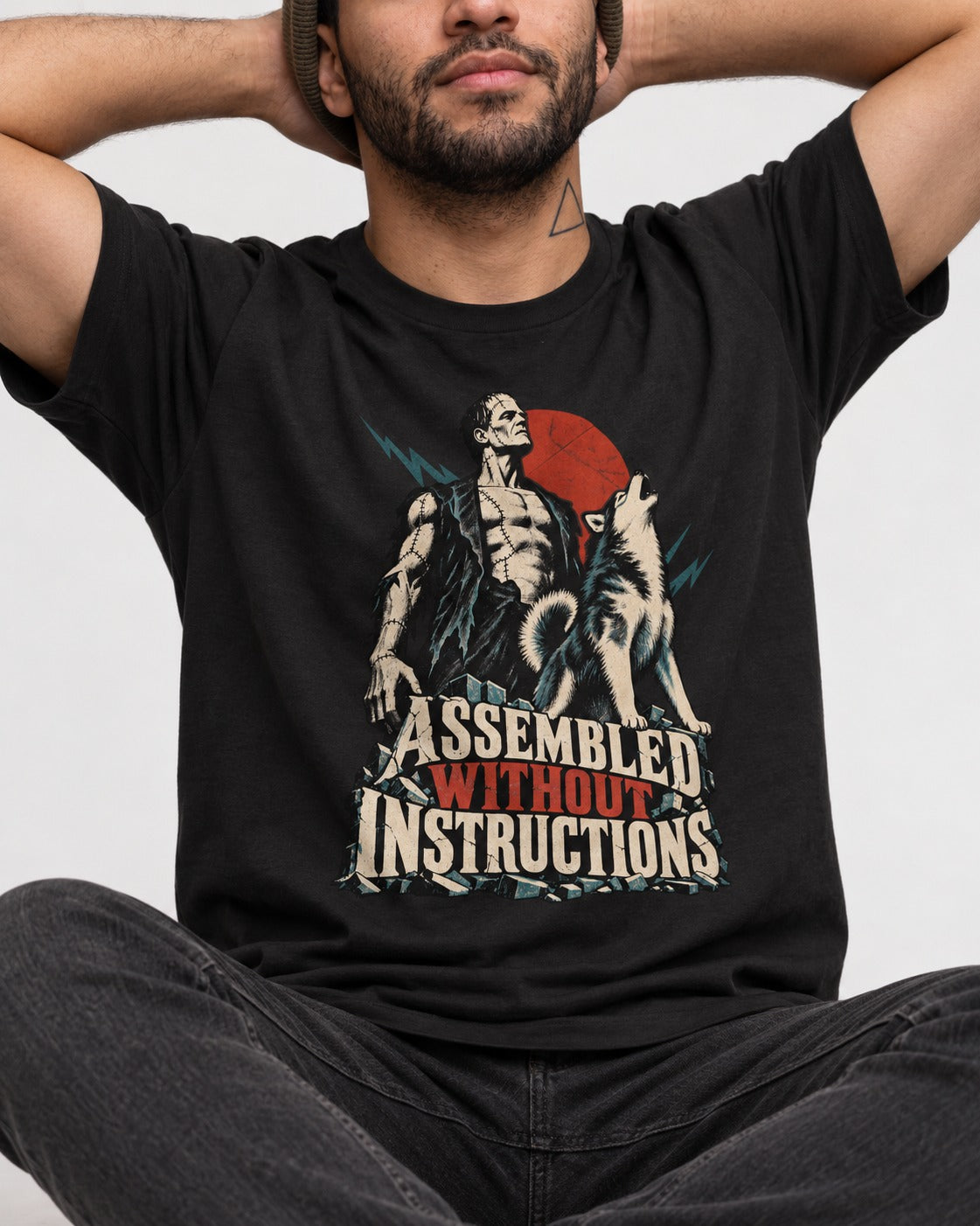 Husky Assembled Without Instructions Frankenstein Graphic T-Shirt in Black, worn by a seated model