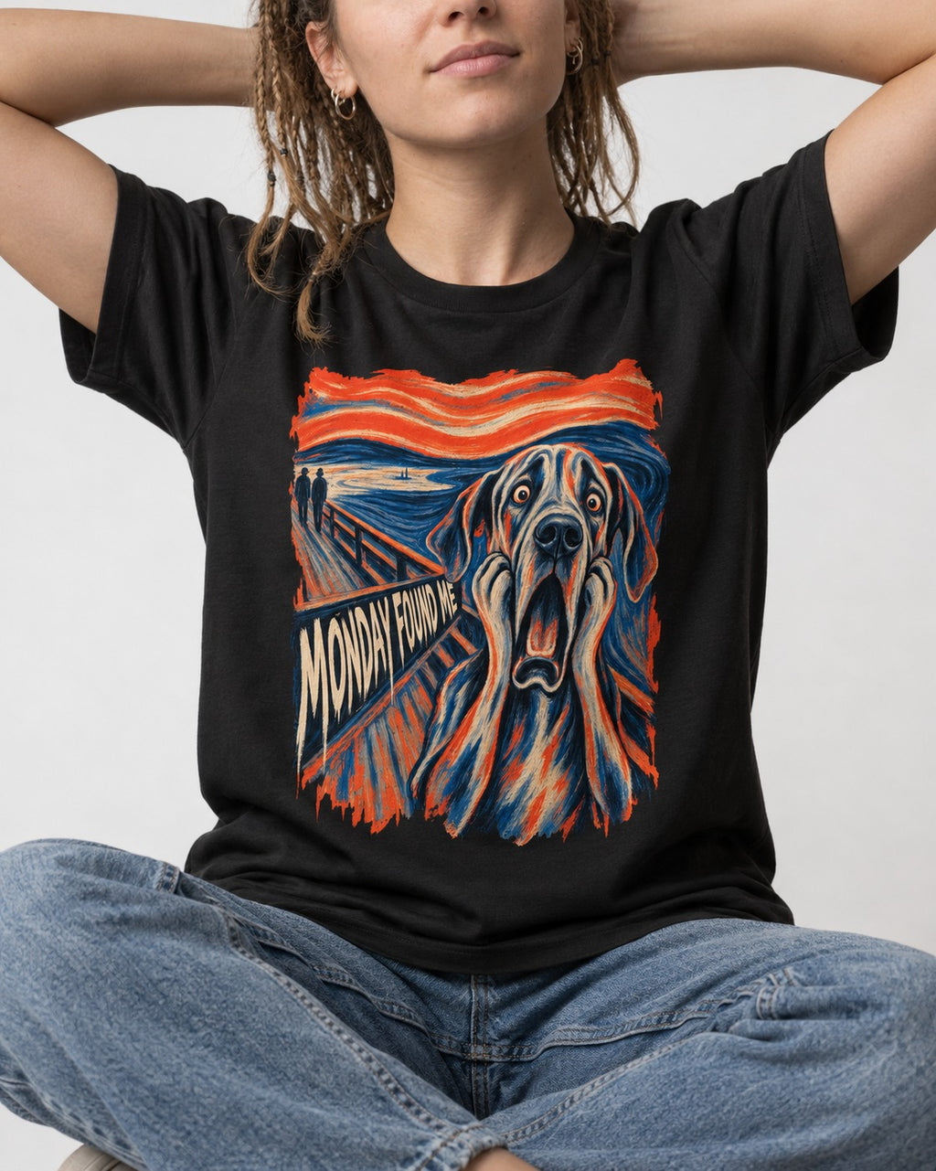Great Dane Monday Found Me Scream Parody Graphic T-Shirt in Black, worn by a seated model