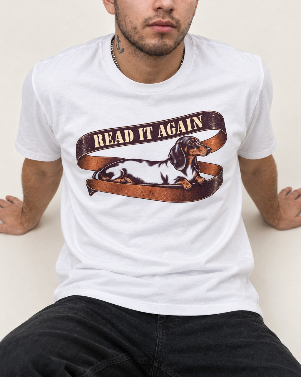 Read It Again Dachshund T-Shirt in White, worn by a seated model