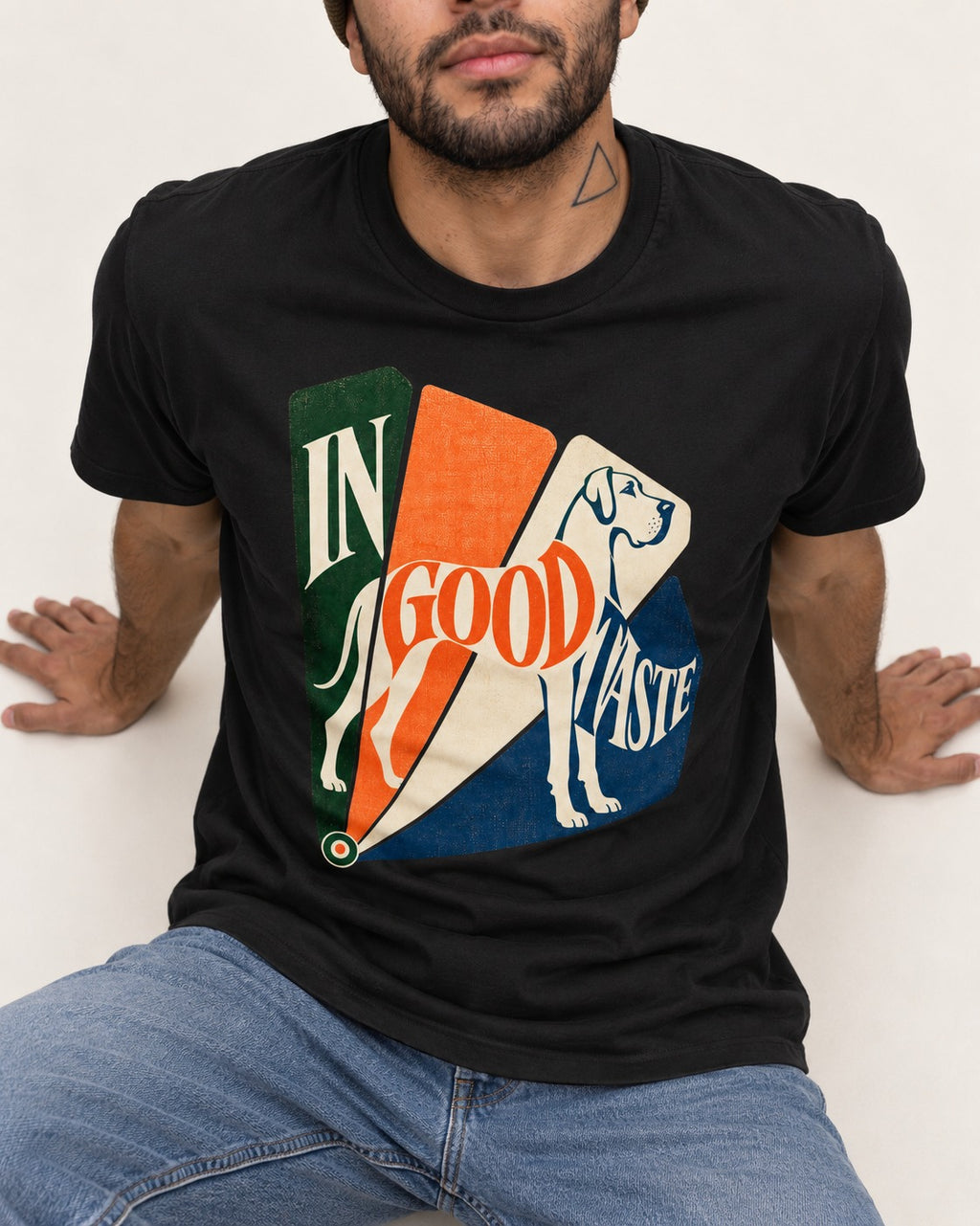 Great Dane In Good Taste Color Fan Graphic T-Shirt in Black, worn by a seated model