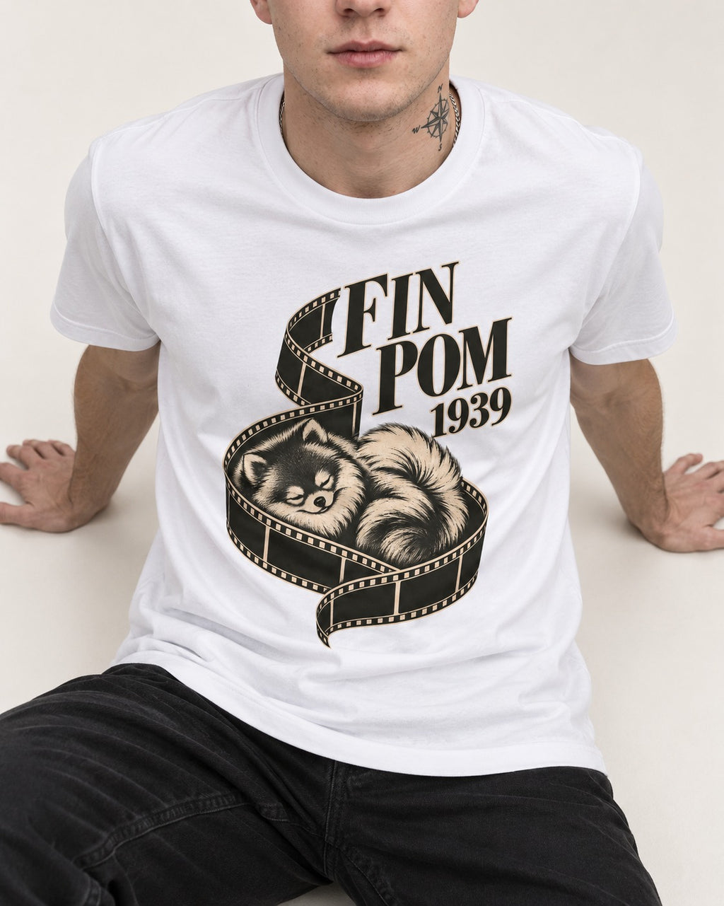 Fin Pomeranian T-Shirt in White, worn by a seated model