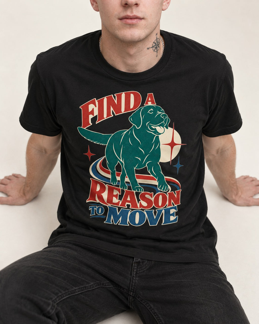 Labrador Retriever Find a Reason to Move Retro Dog Graphic T-Shirt in Black, worn by a seated model