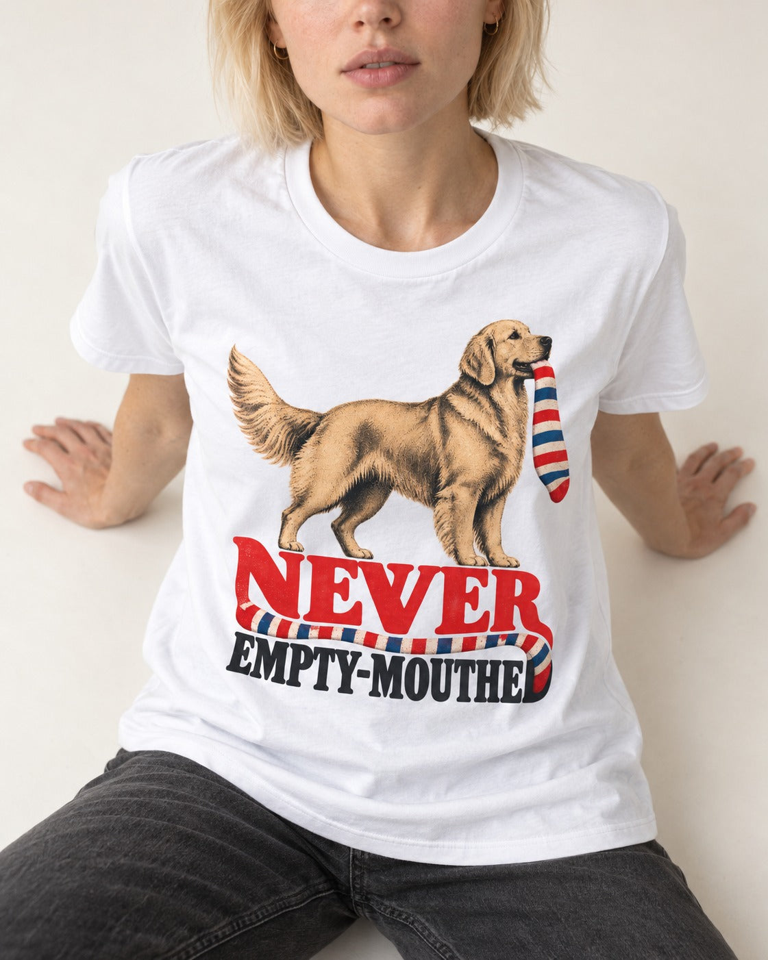 Never Empty Mouthed Golden Retriever T-Shirt in White, worn by a seated model
