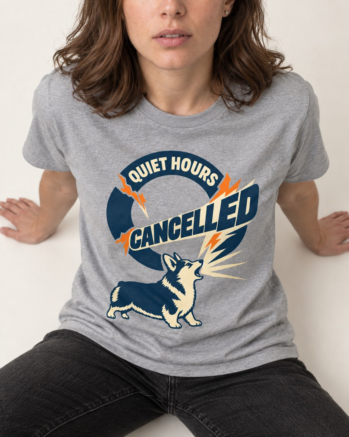 Corgi Quiet Hours Cancelled Calling Badge Graphic T-Shirt in Sport Grey, worn by a seated model