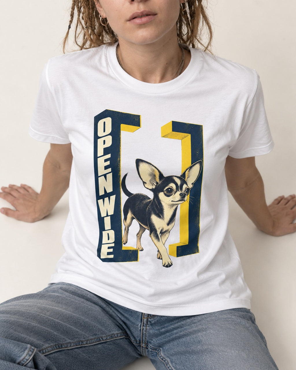 Open Wide Chihuahua T-Shirt in White, worn by a seated model