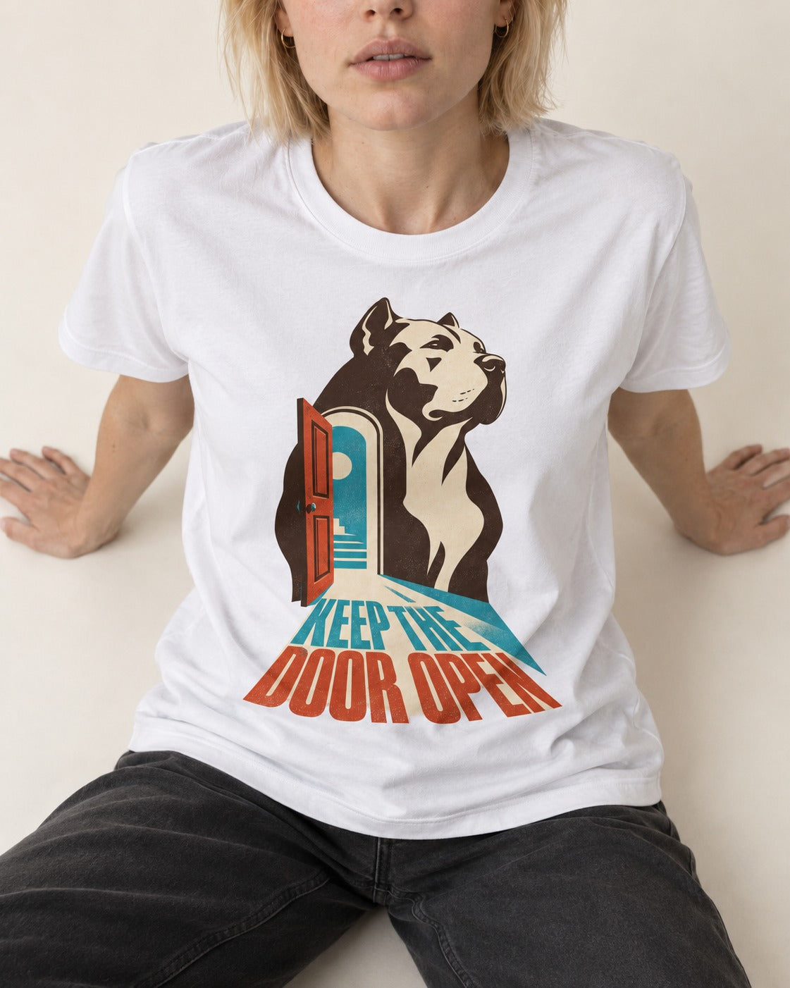 Keep the Door Open Pitbull T-Shirt in White, worn by a seated model