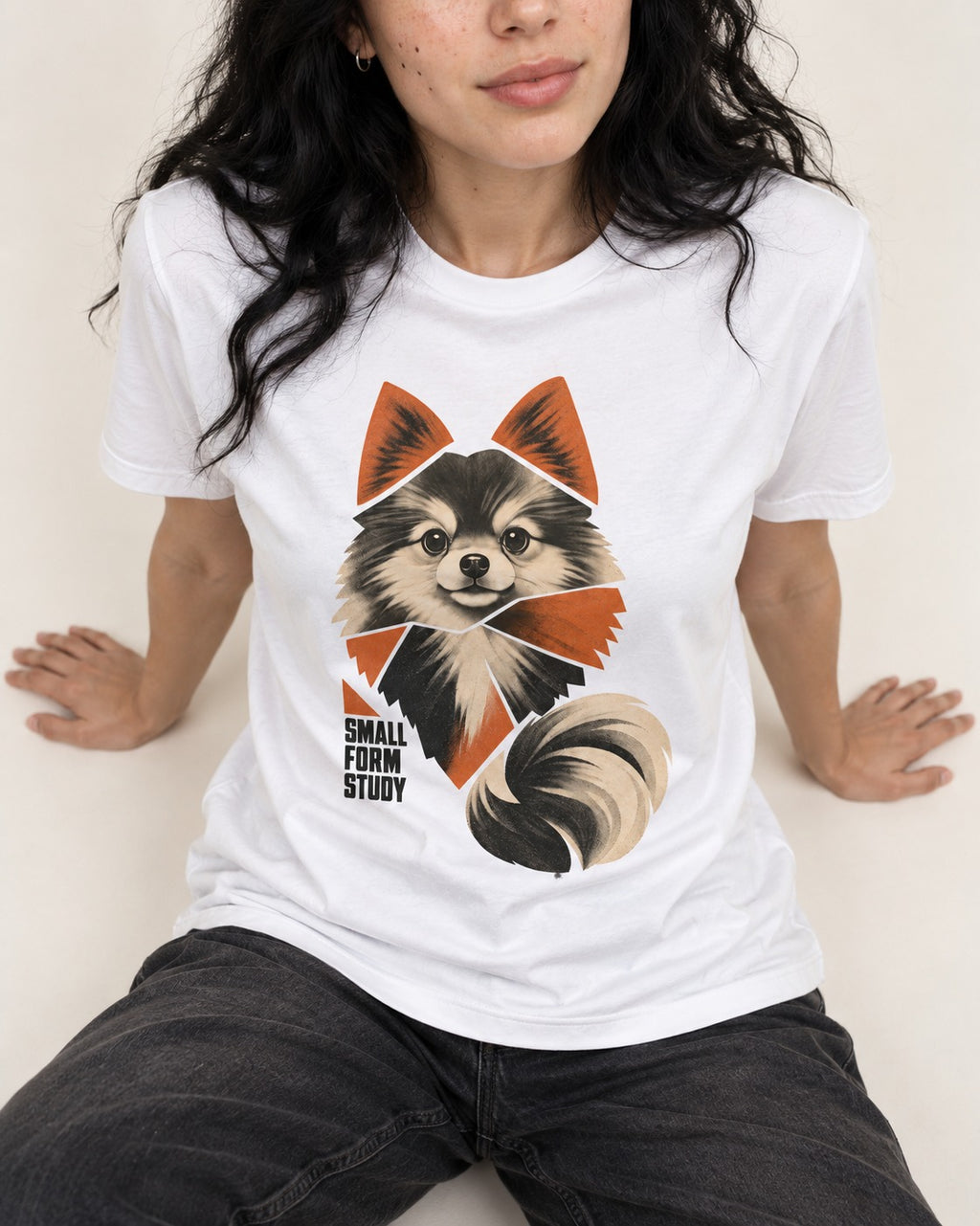 Pomeranian Small Form Study T-Shirt in White, worn by a seated model
