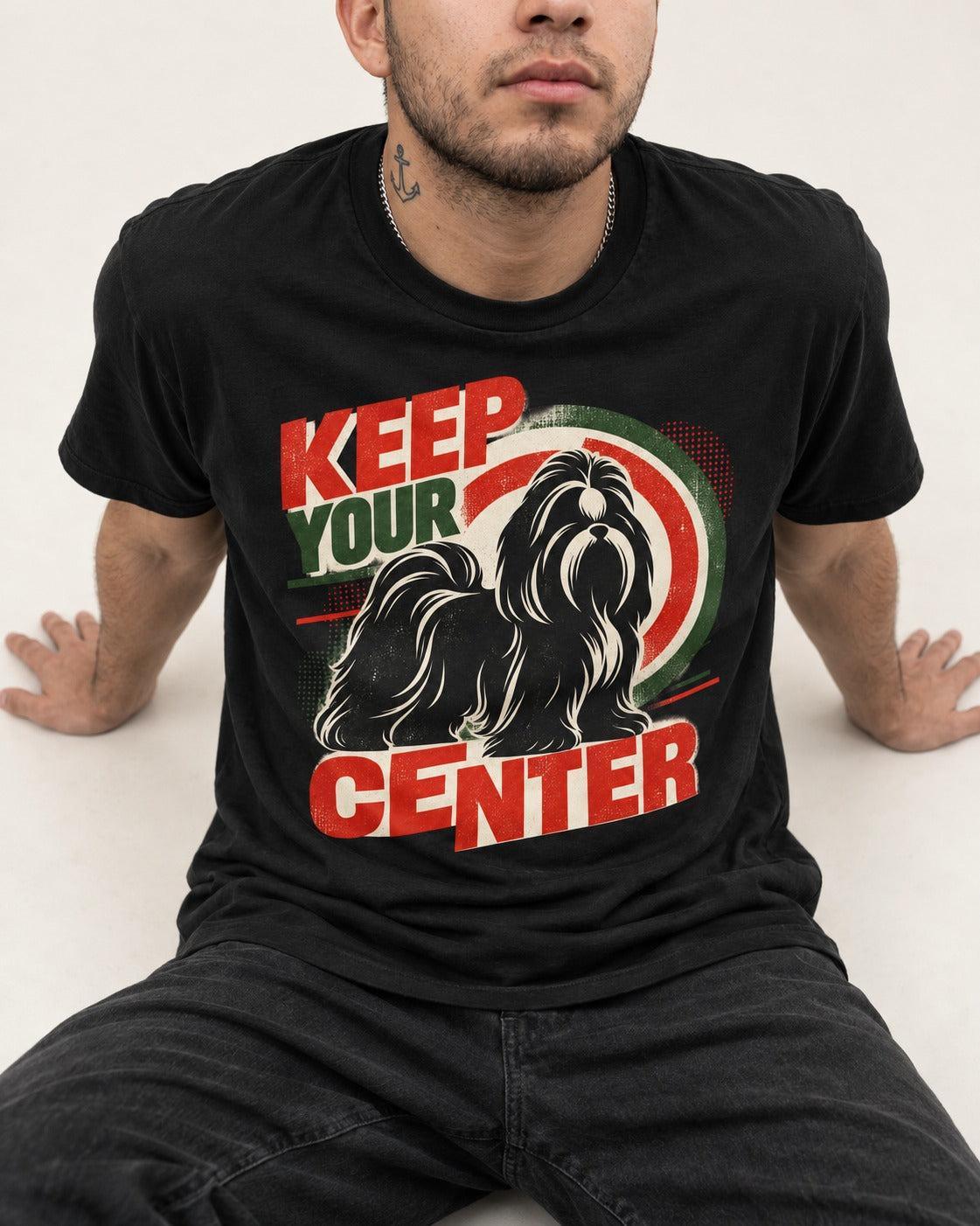 Shih Tzu Keep Your Center Retro Target Graphic T-Shirt in Black, worn by a seated model