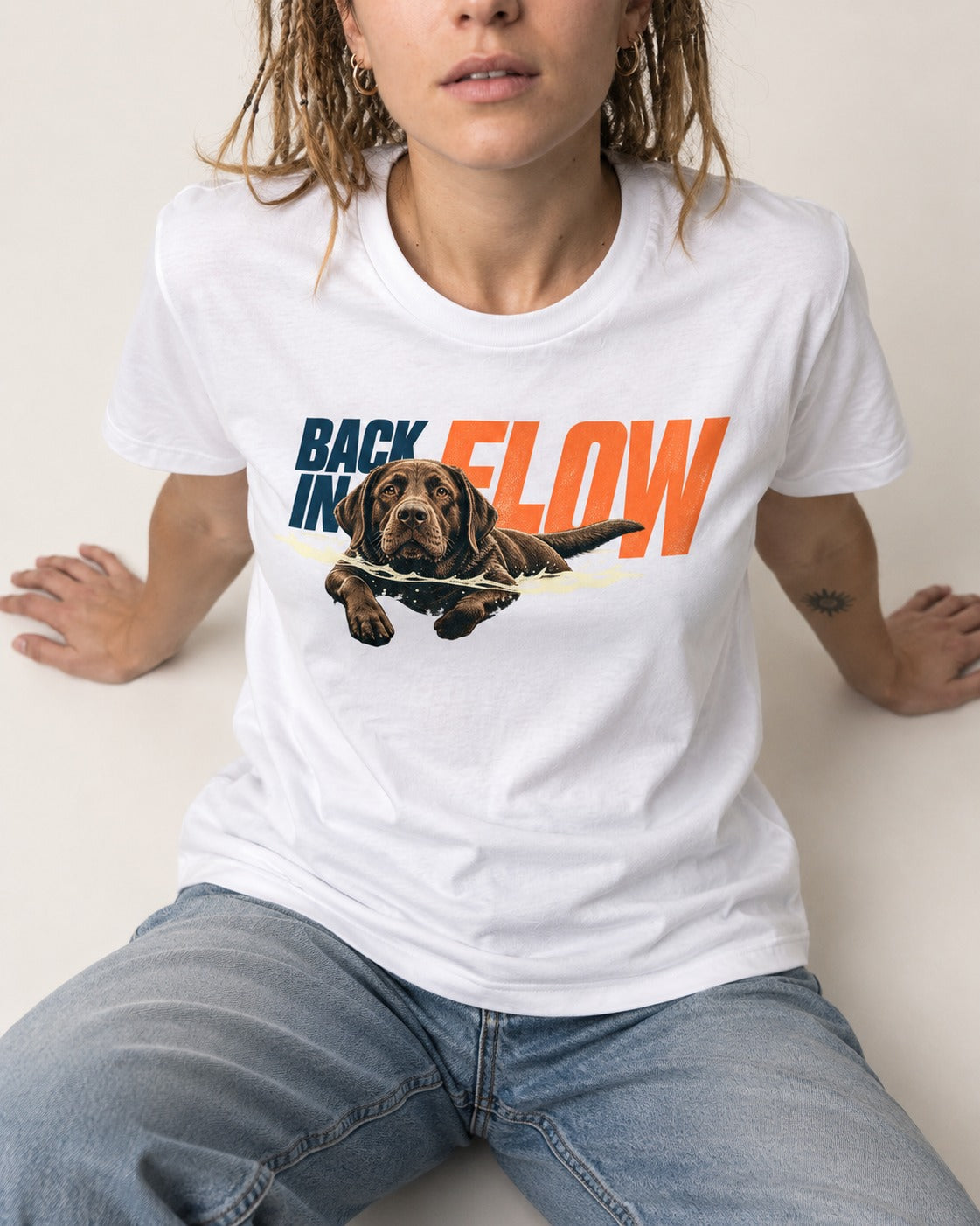 Labrador Retriever Back in Flow T-Shirt in White, worn by a seated model