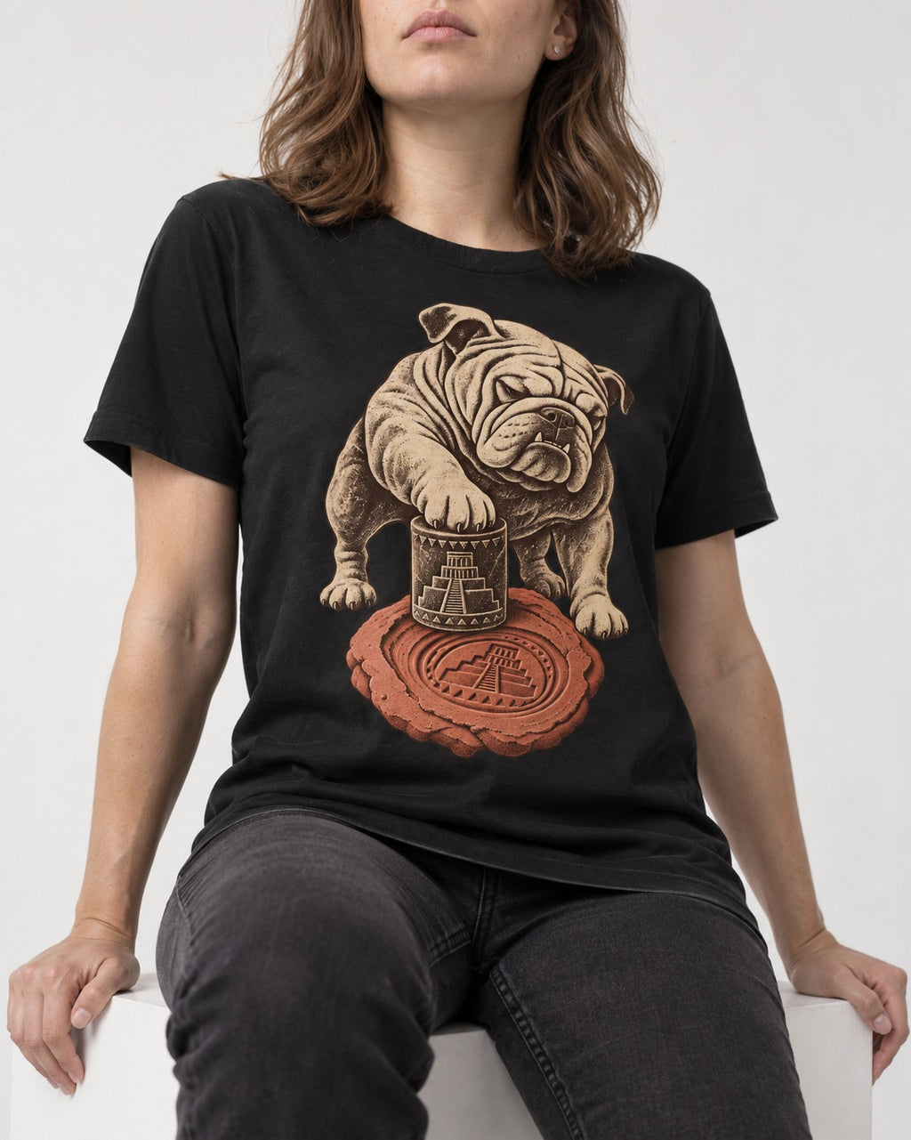 English Bulldog Ancient Cylinder Seal Graphic T-Shirt in Black, worn by a seated model