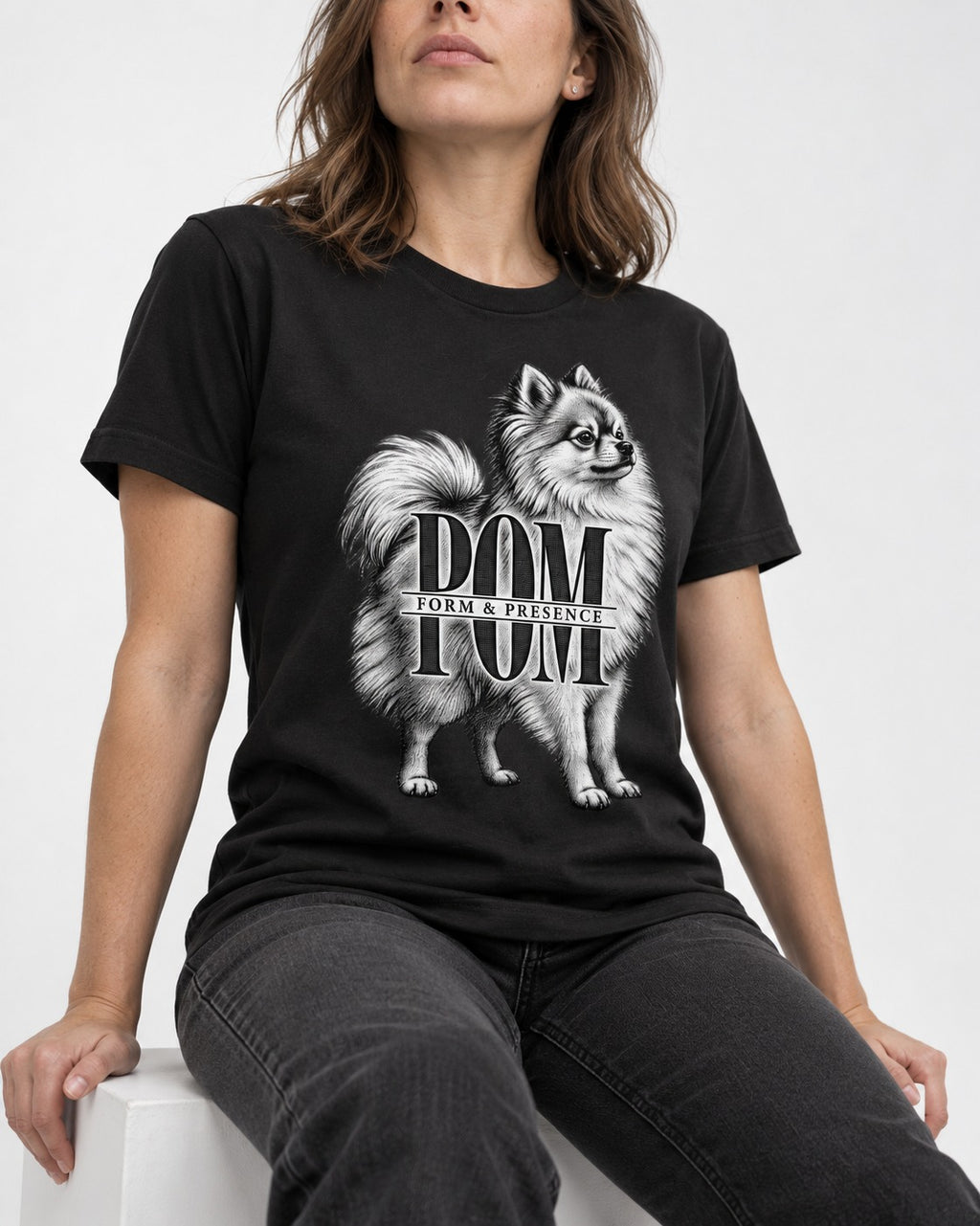 Pomeranian Form and Presence Monogram Graphic T-Shirt in Black, worn by a seated model