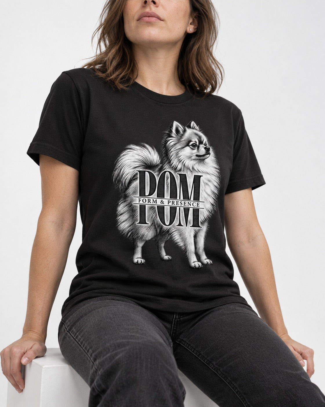Pomeranian Form and Presence Monogram Graphic T-Shirt in Black, worn by a seated model