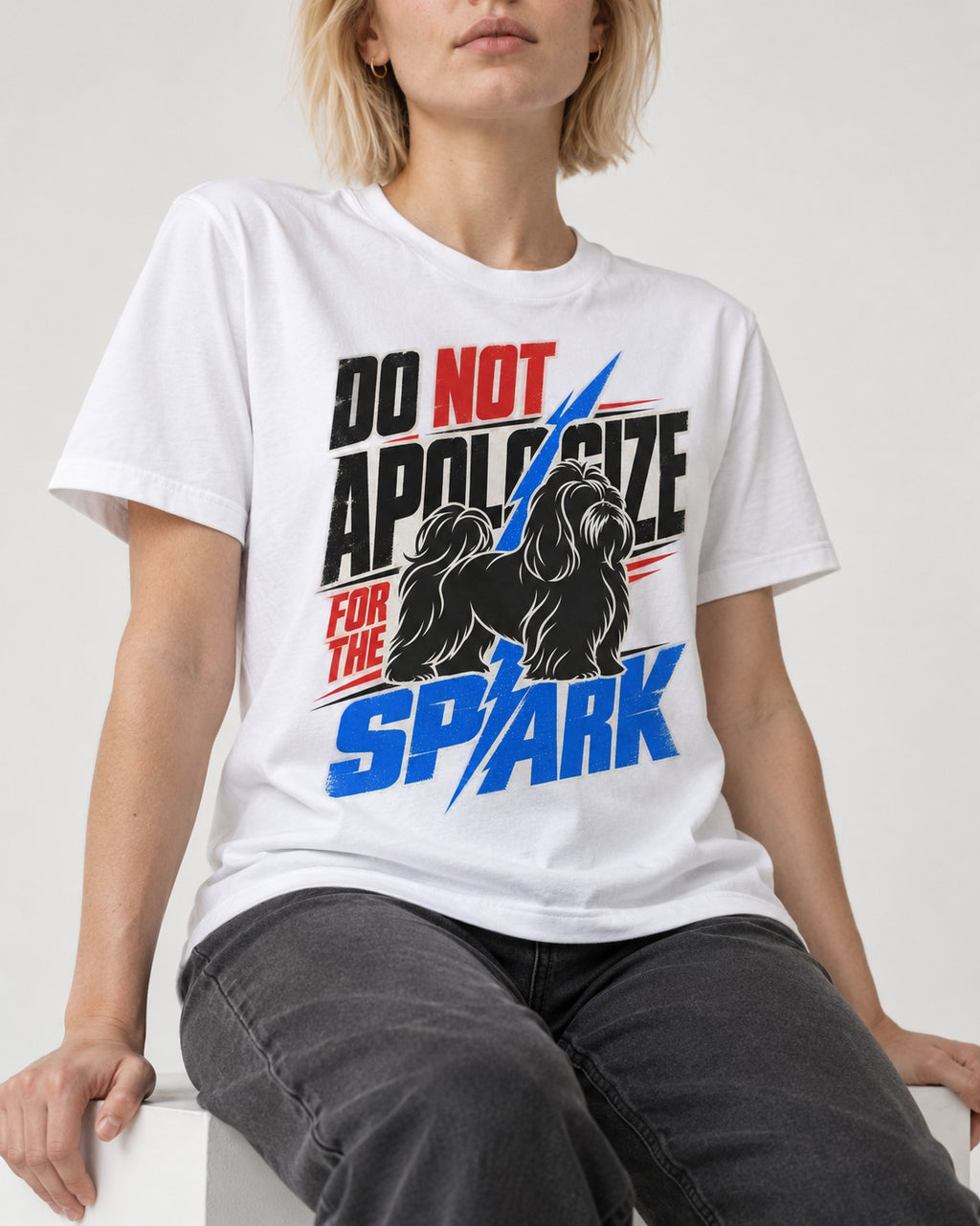 Never Apologize for Shih Tzu Spark T-Shirt in White, worn by a seated model