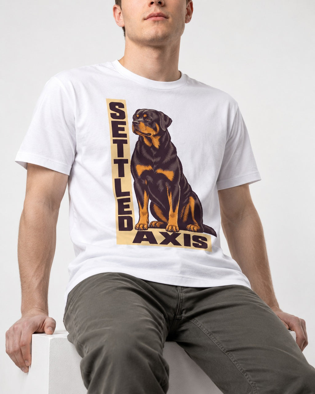 Settled Axis Rottweiler T-Shirt in White, worn by a seated model