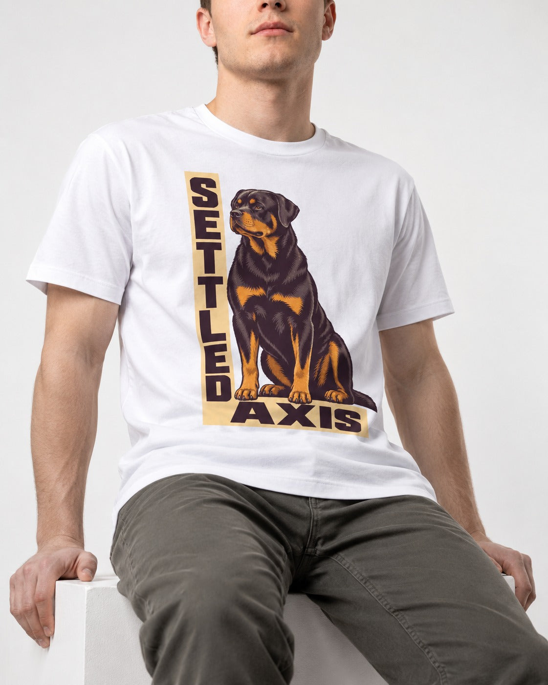 Settled Axis Rottweiler T-Shirt in White, worn by a seated model