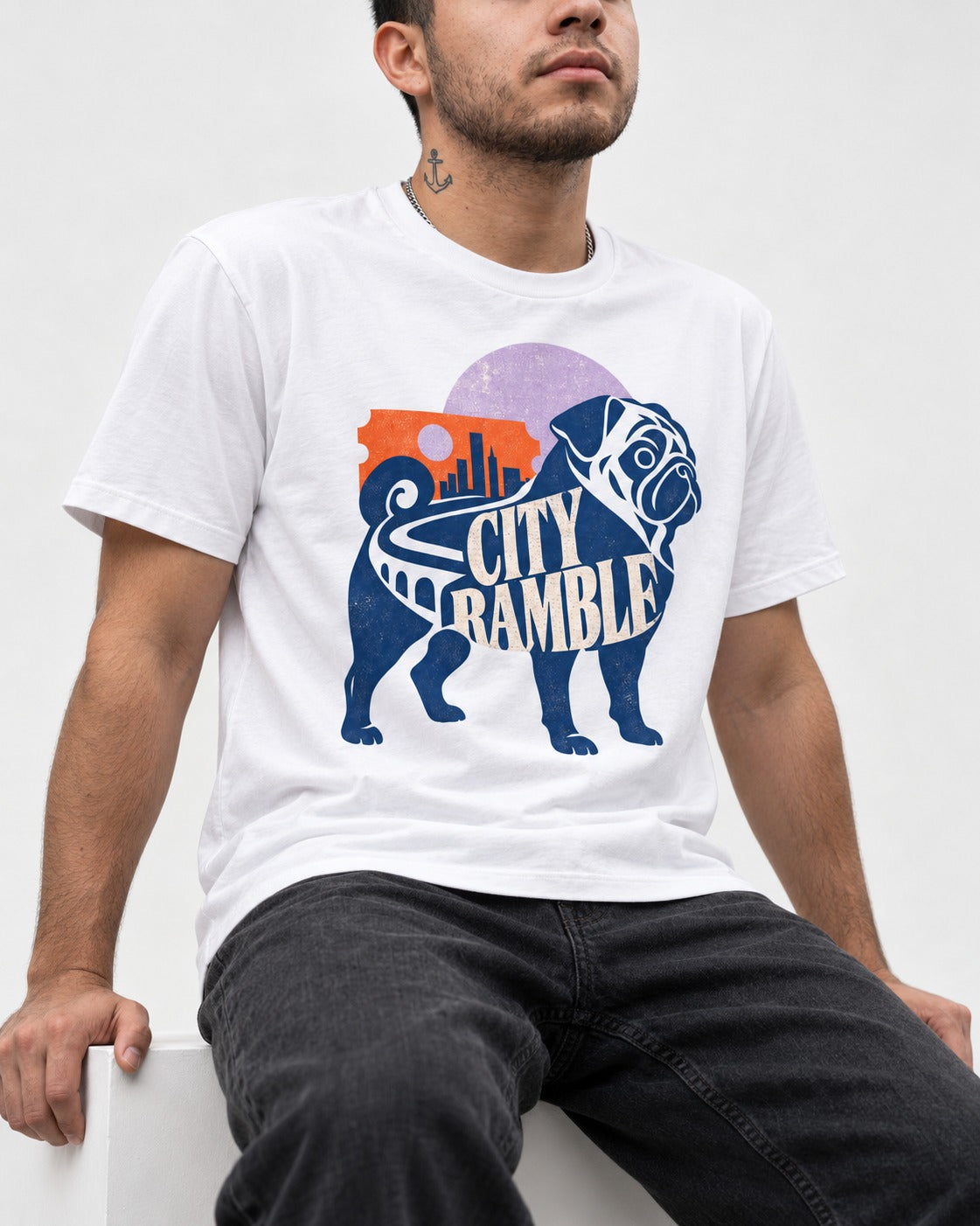 Pug's Big City Ramble T-Shirt in White, worn by a seated model