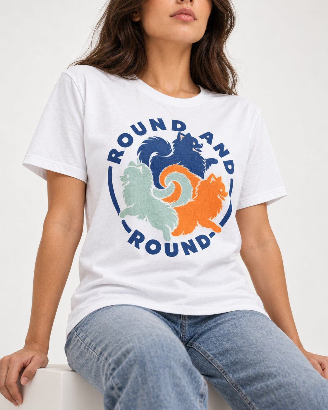 Pomeranian Round and Round T-Shirt in White, worn by a seated model