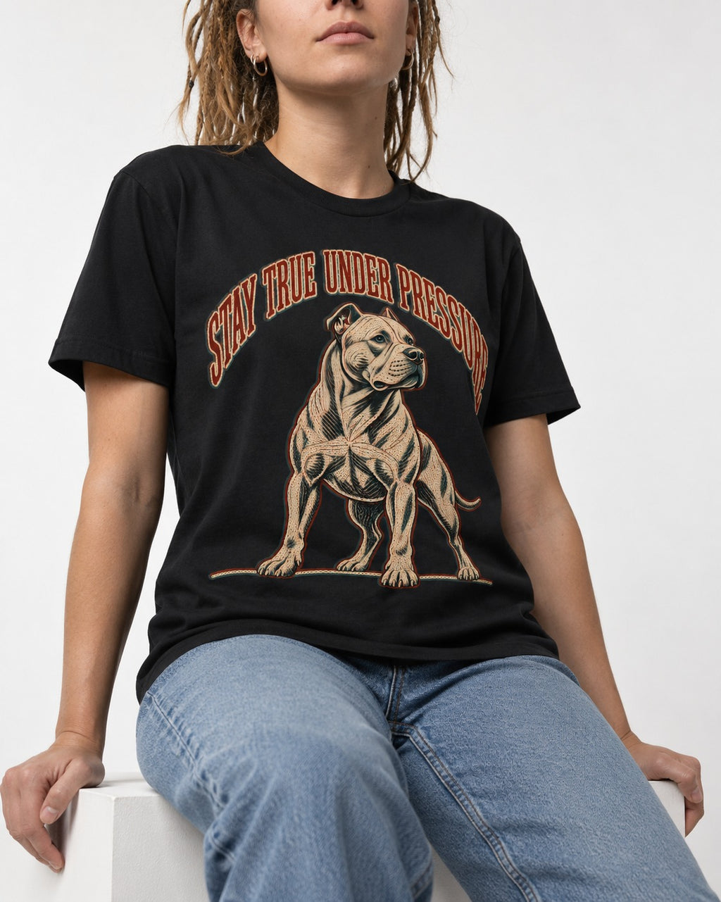 Pitbull Stay True Under Pressure Stance Graphic T-Shirt in Black, worn by a seated model