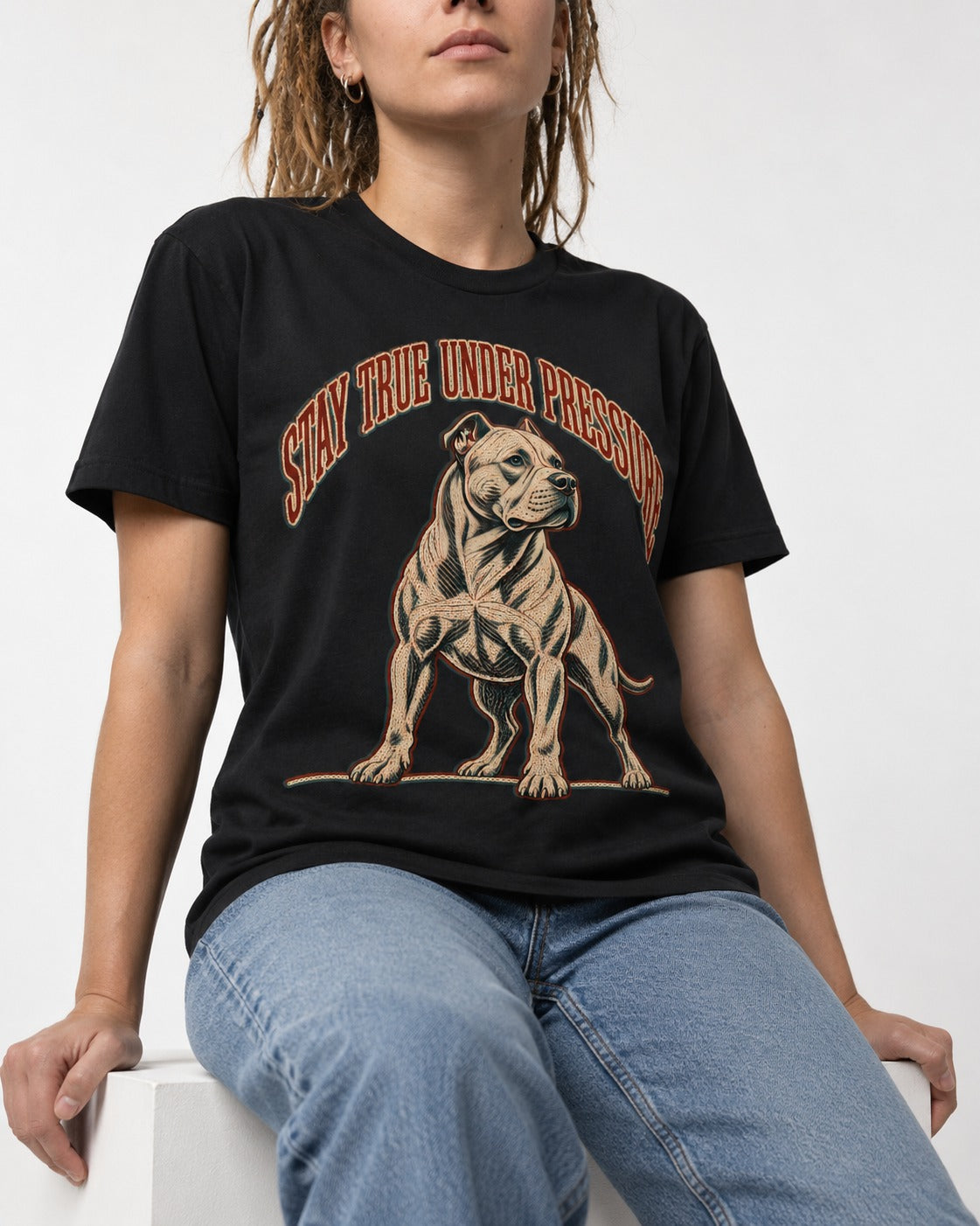 Pitbull Stay True Under Pressure Stance Graphic T-Shirt in Black, worn by a seated model