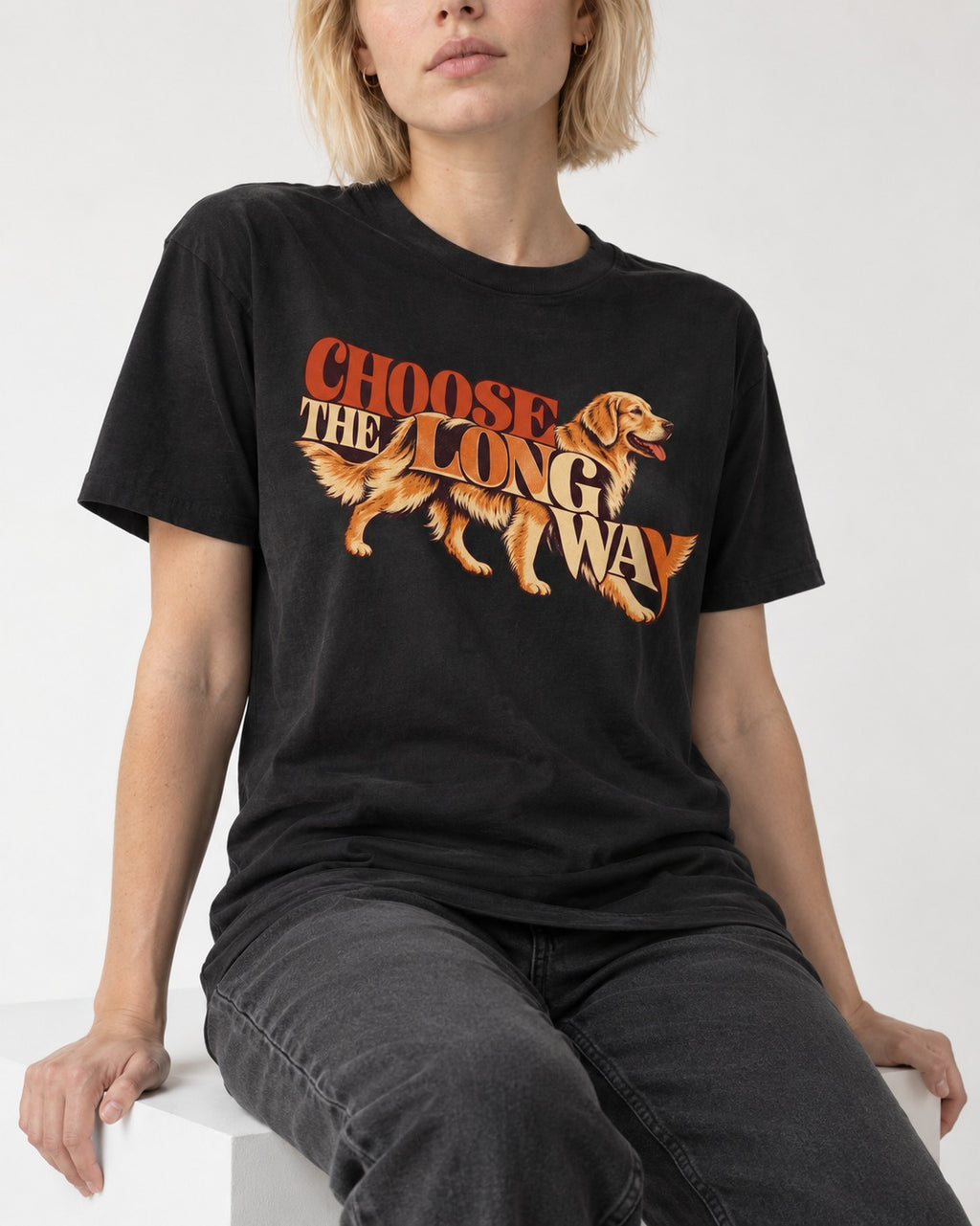 Golden Retriever Choose The Long Way Retro Graphic T-Shirt in Black, worn by a seated model
