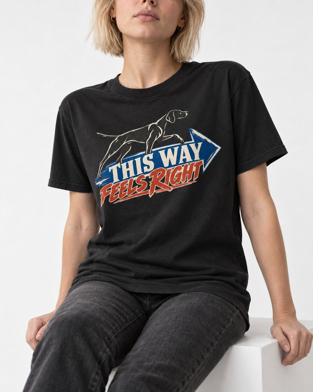 This Way Feels Right Arrow German Shorthaired Pointer Graphic T-Shirt in Black, worn by a seated model