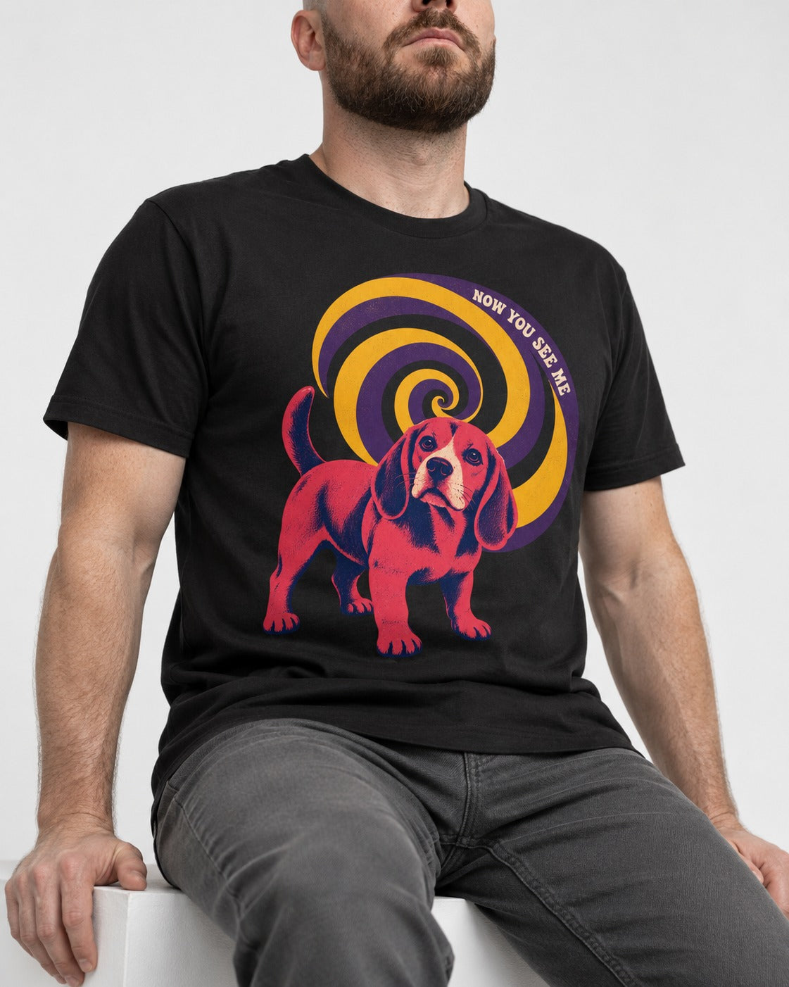 Now You See Me Beagle Spiral T-Shirt in Black, worn by a seated model